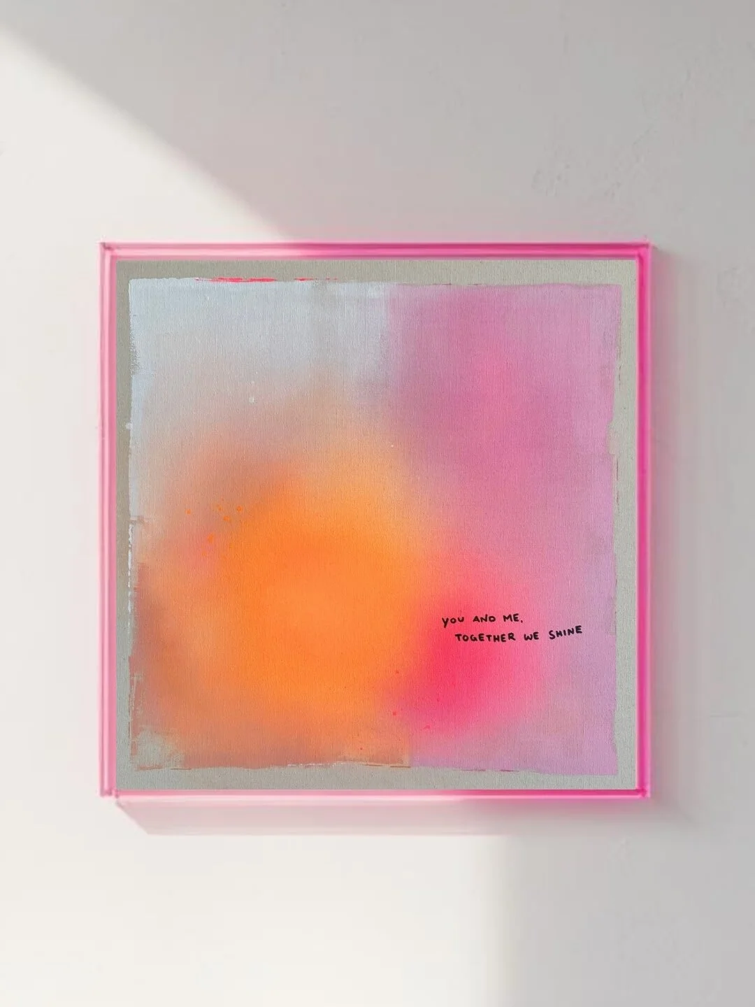 Luminous artwork with smooth color transitions in white, orange, and rose pink, featuring the subtle written quote 'you and me, together we shine' by Vanessa Ochi