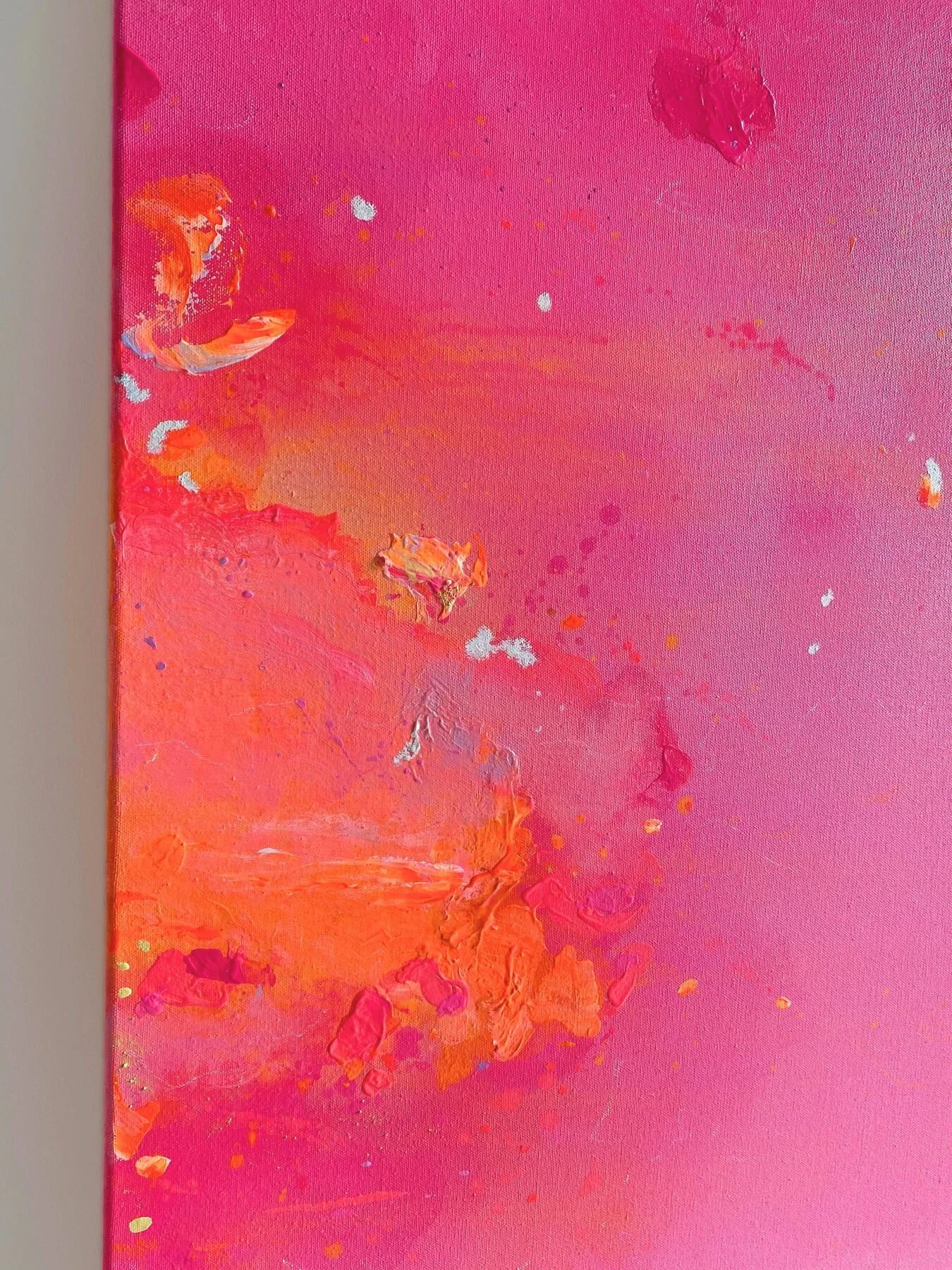 Detail shot showing smooth transitions between radiant orange, rose, and deep pink hues with subtle canvas texture