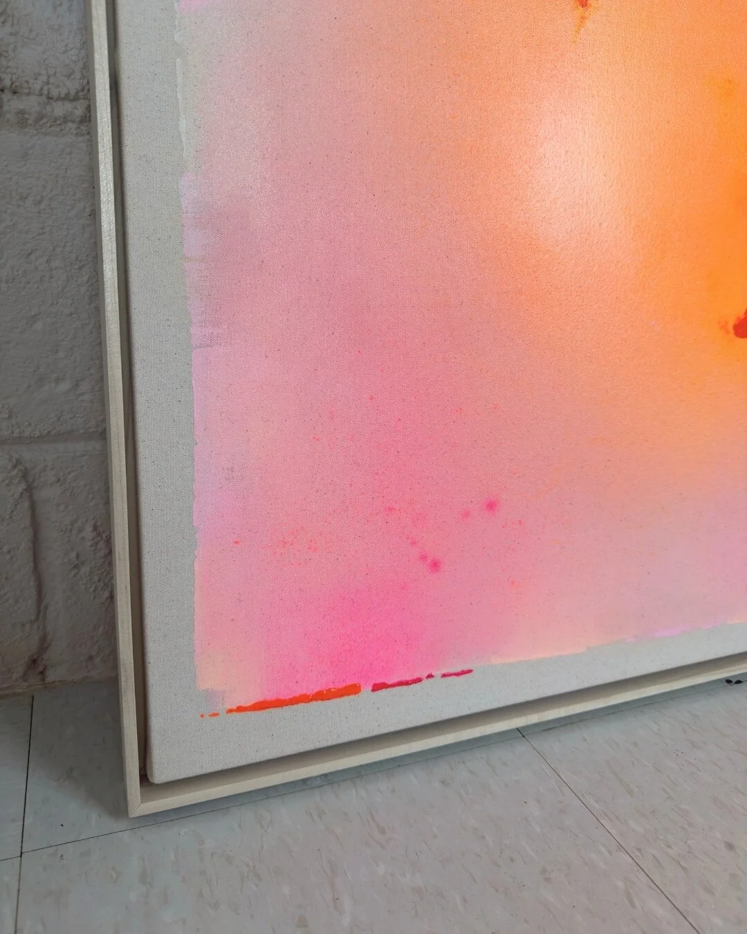 Detail shot showing delicate sparkle, purple accents, and soft canvas texture in a pink and orange gradient painting
