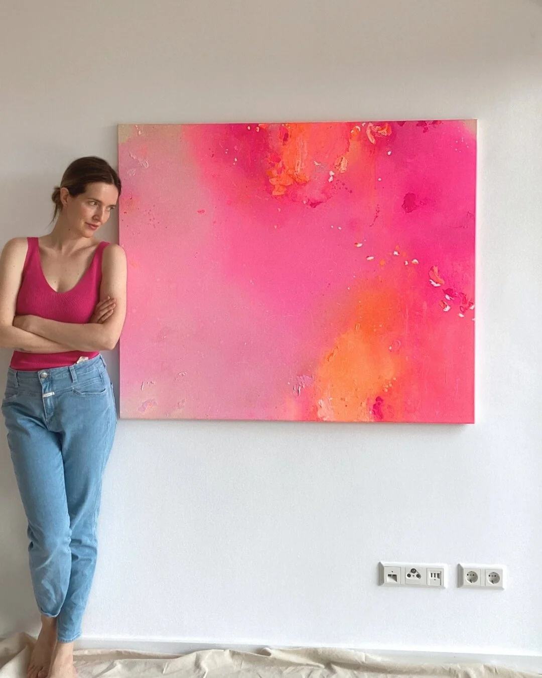 Pink Euphoria, an original abstract canvas painting featuring intense gradients of pink, red, rose, and orange with the artist Vanessa Ochi