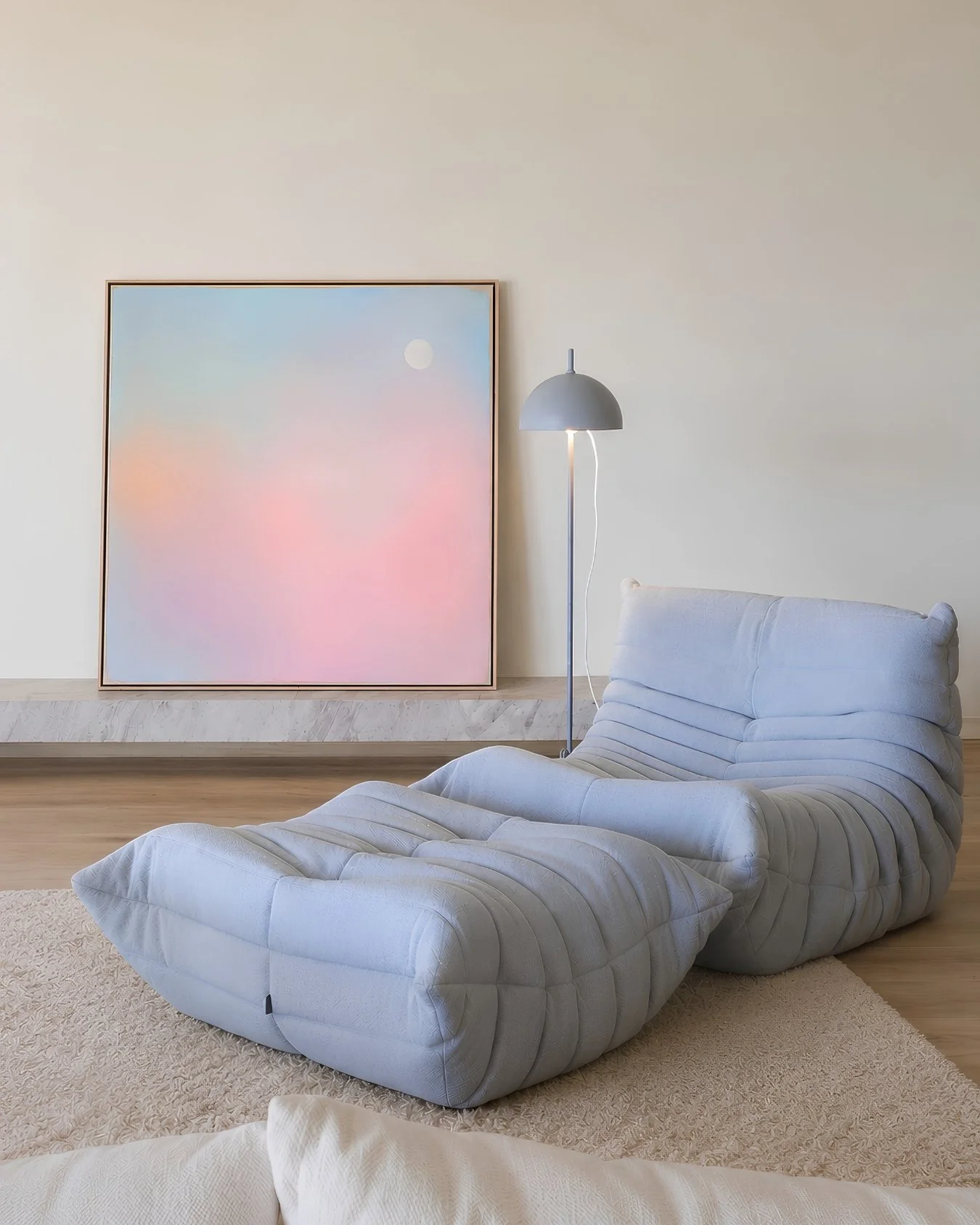 mockup: Large abstract canvas art depicting a dreamy atmospheric sky with seamless transitions of pastel blue, soft pink, and warm orange by Vanessa Ochi
