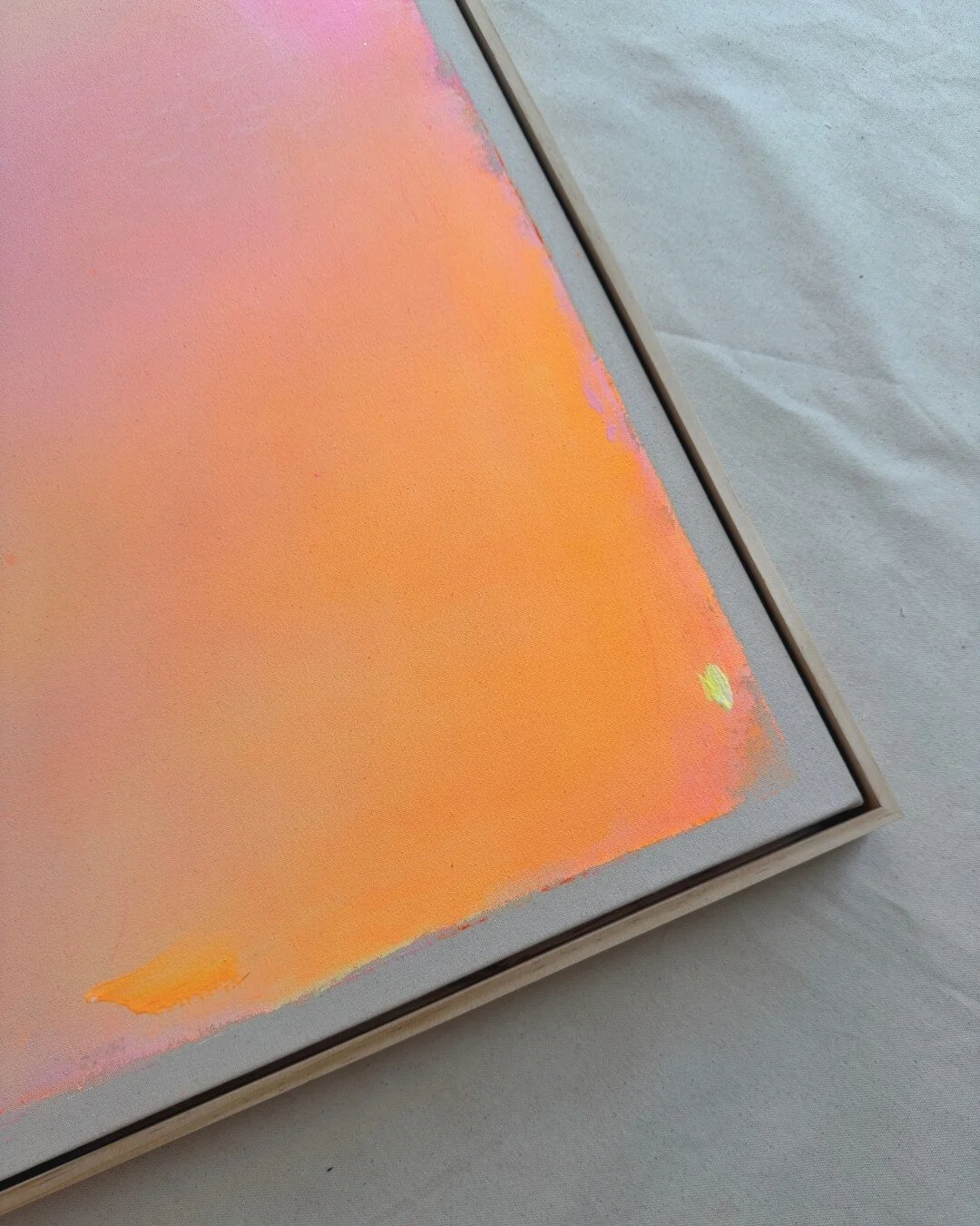 Close-up detail of subtle glitter accents and smooth color transitions in purple, pink, orange, and yellow on a canvas by Vanessa Ochi