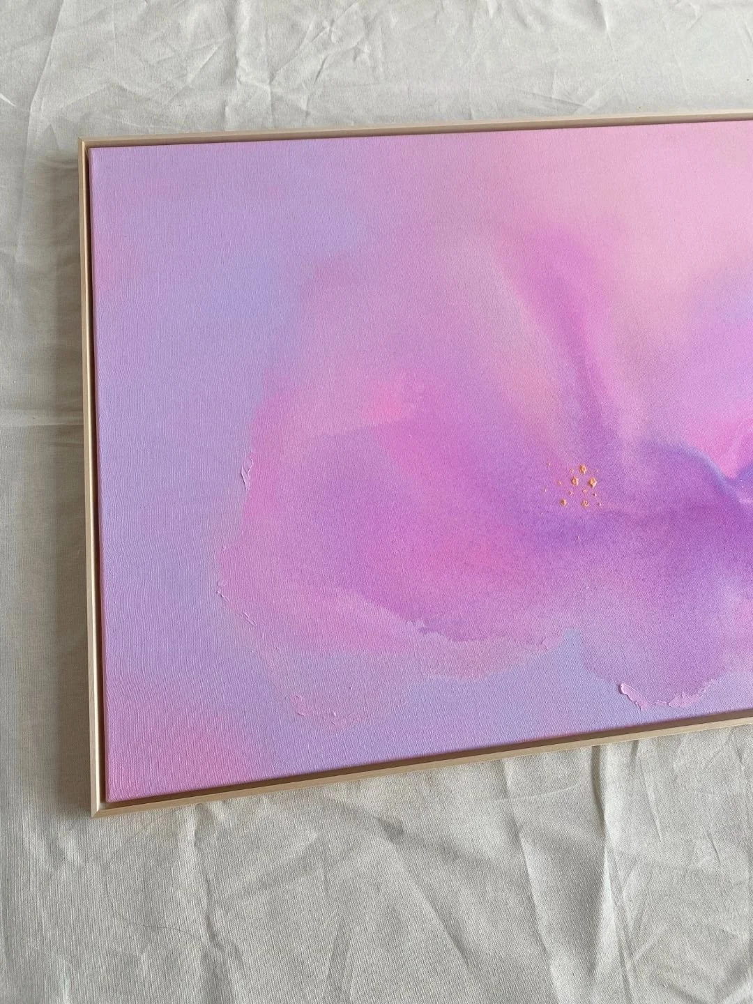 Detail shot showing the subtle canvas texture and cloud-like purple color transitions of Soft Bloom by Vanessa Ochi.