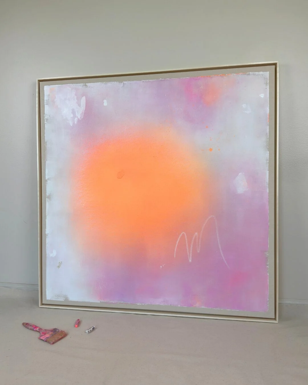 Dreamy abstract canvas art depicting a bright white center with delicate glitter set against a warm pink and orange background by Vanessa Ochi