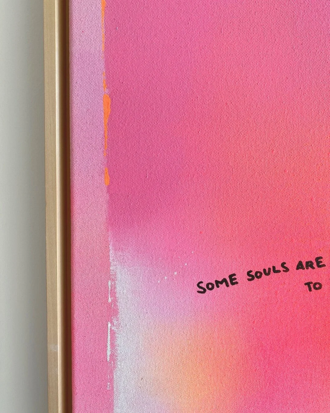 Close-up detail of the written text 'Some souls are meant to meet – again and again, forever' over radiant neon orange and pink gradients by Vanessa Ochi