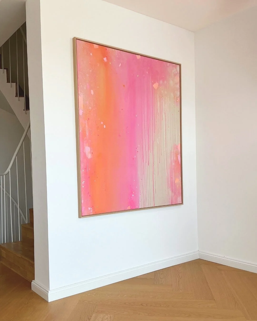 Dreamy sunset-inspired abstract canvas art depicting soft color transitions of coral and pink with gentle downward paint drips by Vanessa Ochi.
