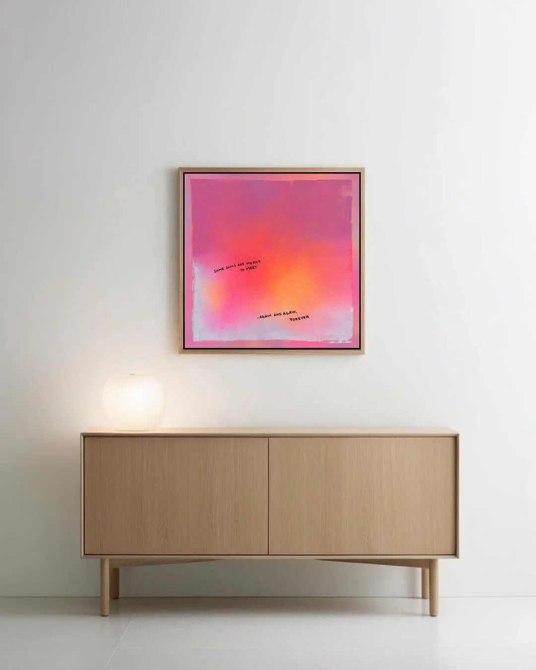 Modern space featuring a vibrant neon orange and pink abstract statement artwork with poetic text mounted on a minimalist wall