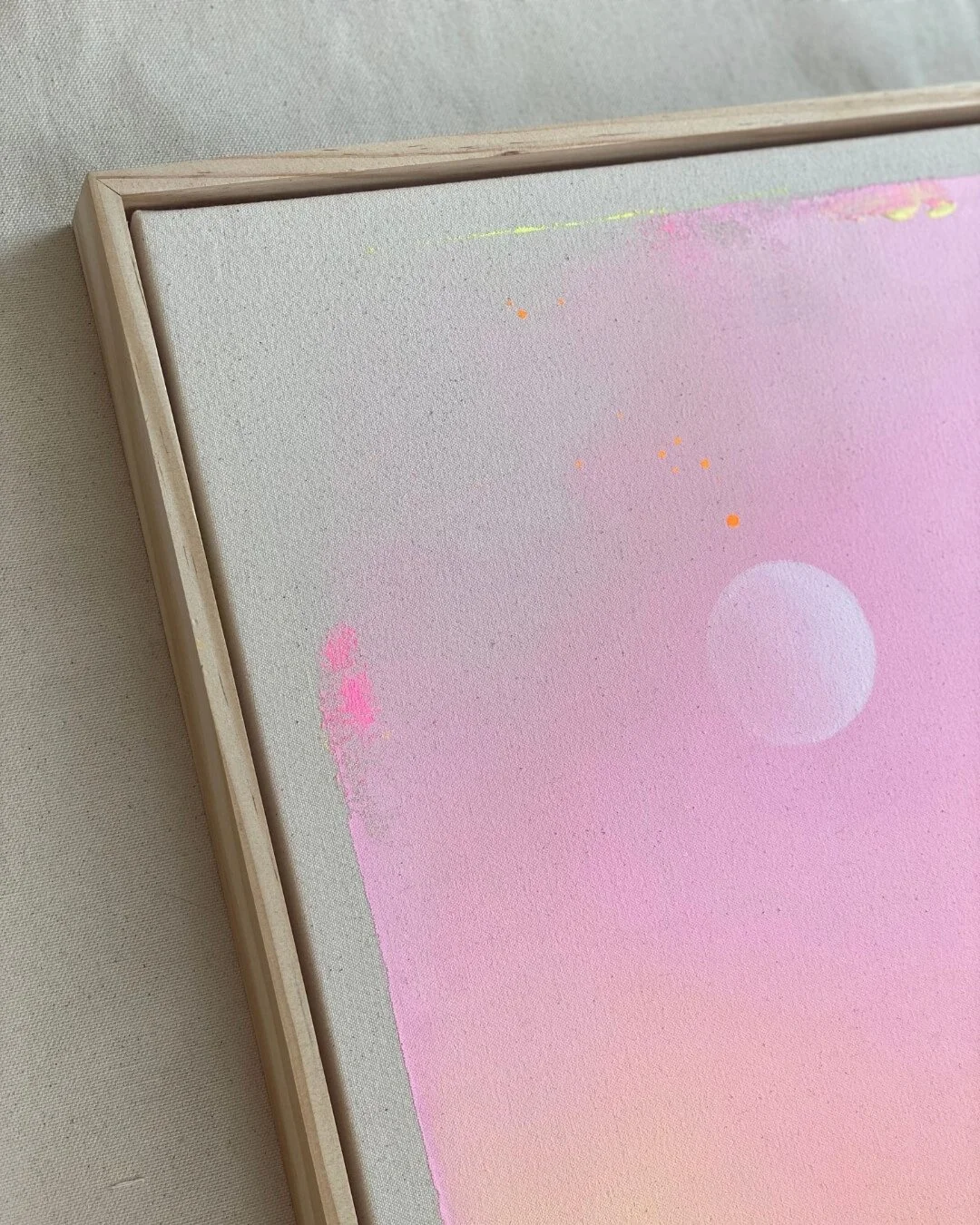 Close-up detail of subtle glitter accents and smooth color transitions in purple, pink, orange, and yellow on a canvas by Vanessa Ochi.