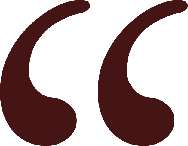 Close-up of brown quotation marks on a black background.