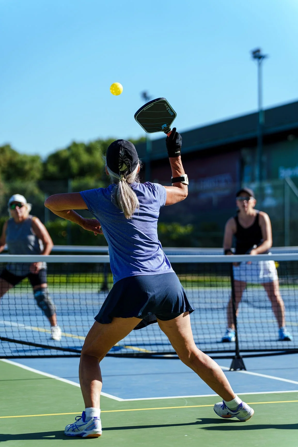 A competitor hitting a pickleball during the Lisboa Op