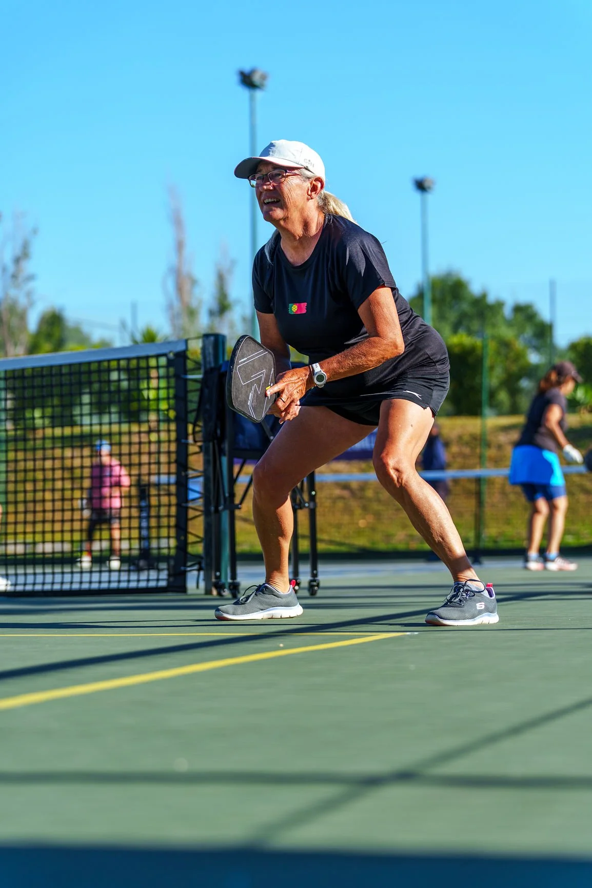 Lisbon pickleball tournament game with a player hitting a pickleball on the pickleball court