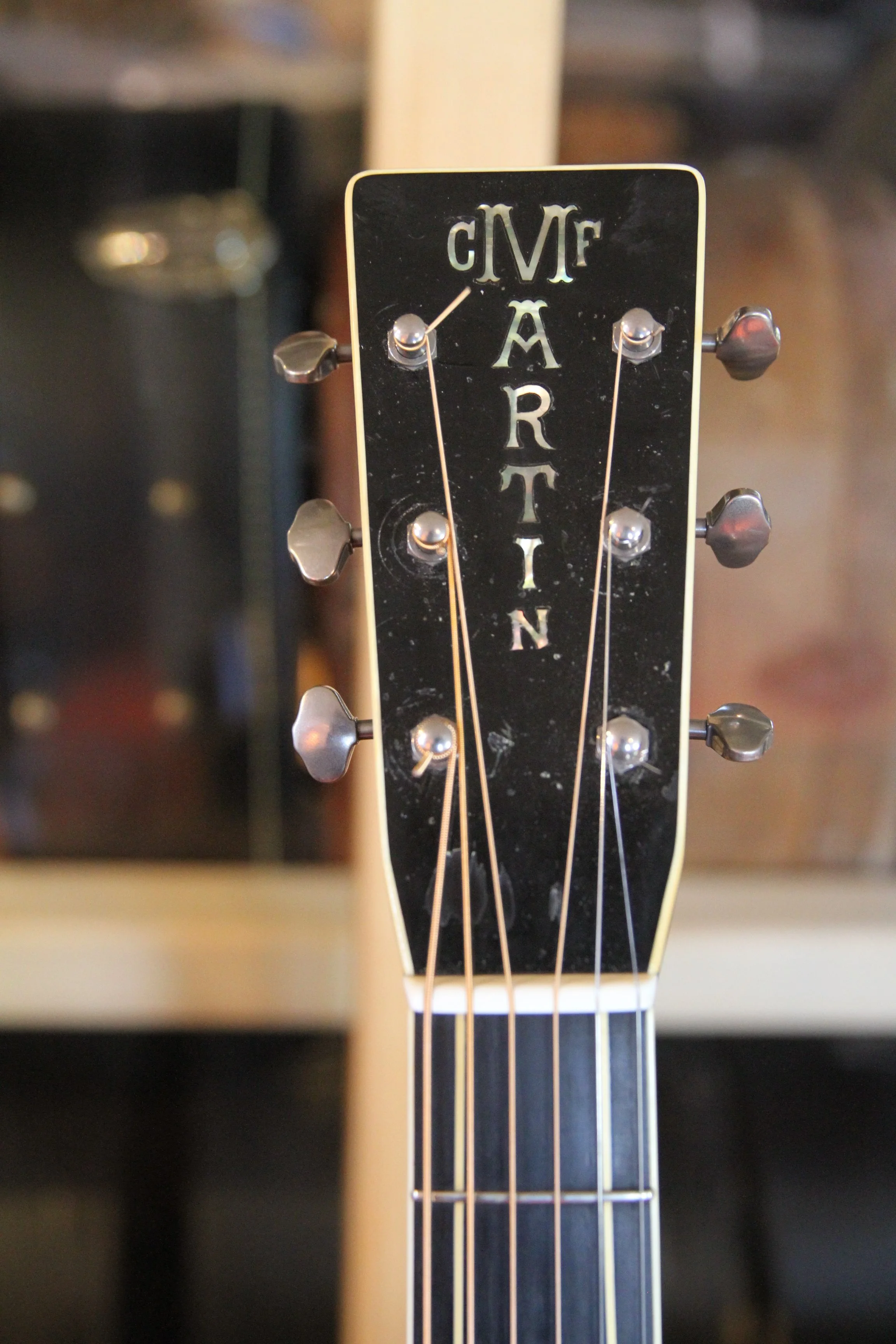 Close-up of a prewar Martin F-7 guitar headstock with tuning pegs