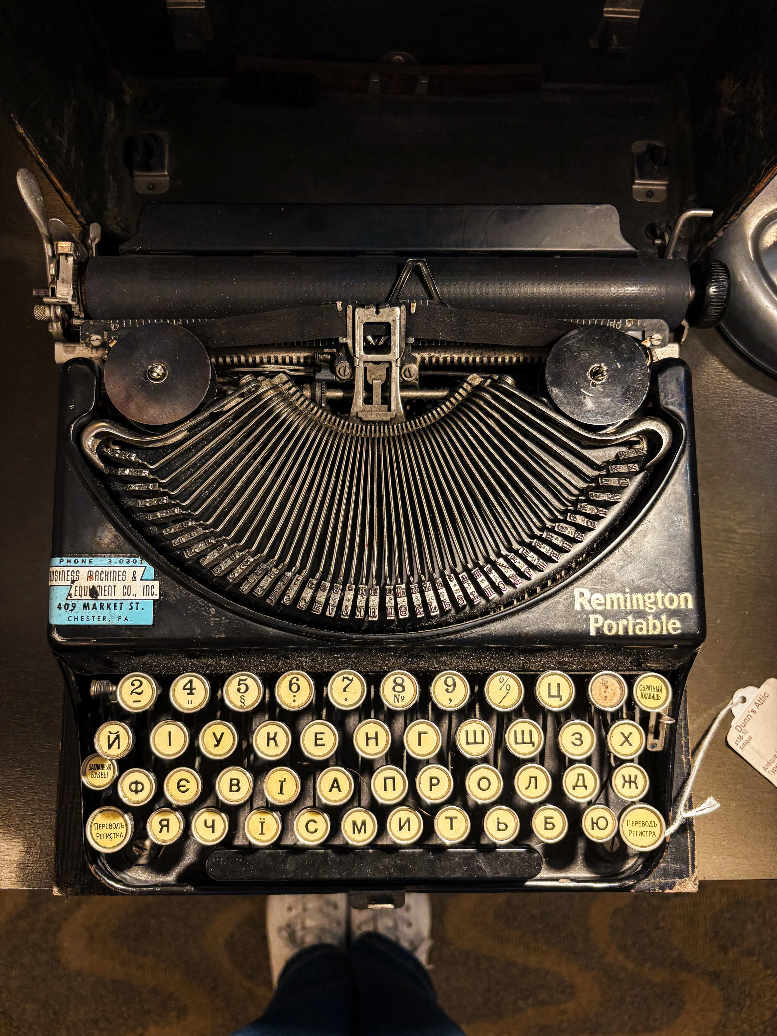 Vintage Remington portable typewriter with Cyrillic keyboard and exposed typebars