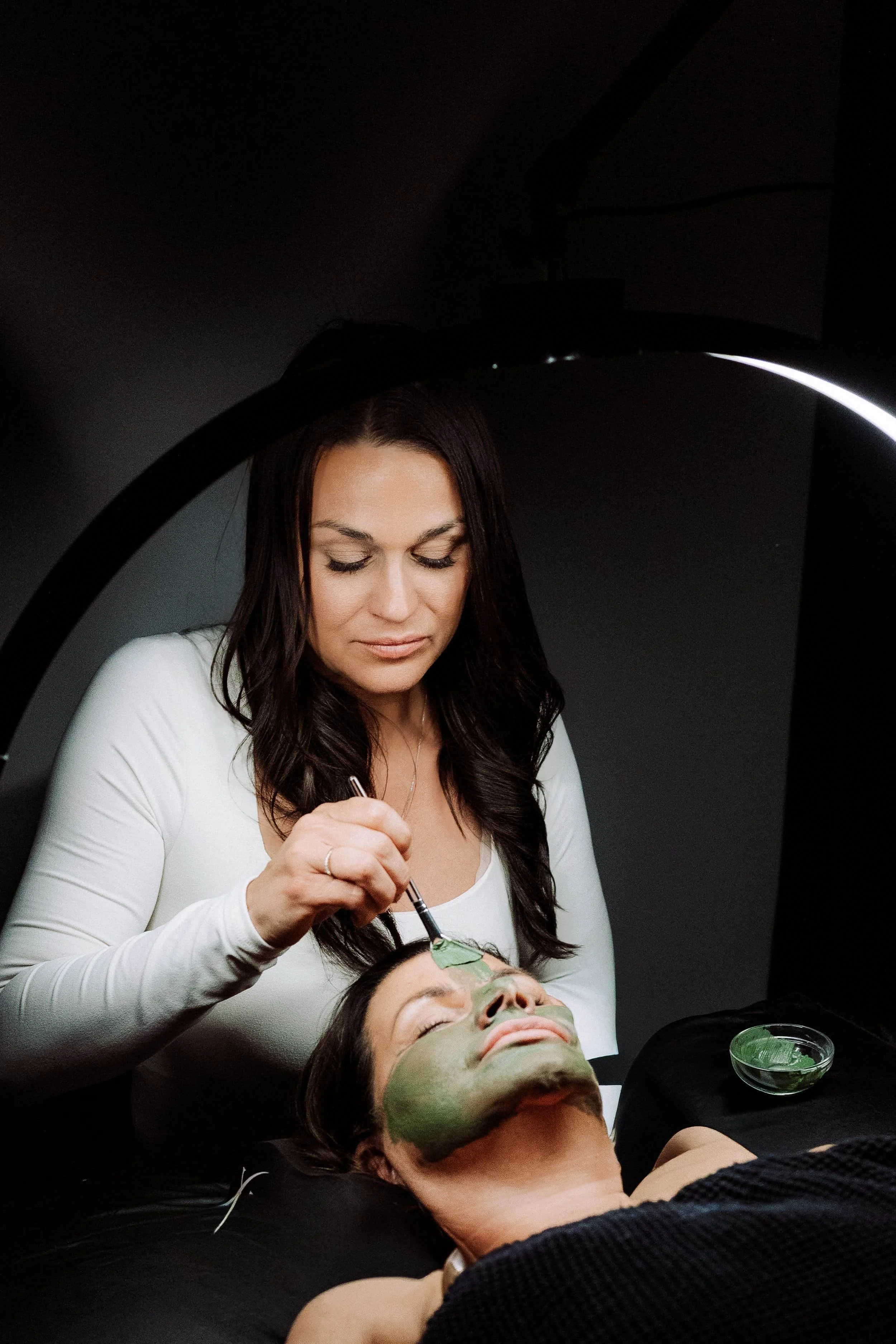 Woman Applies Facial Mask
