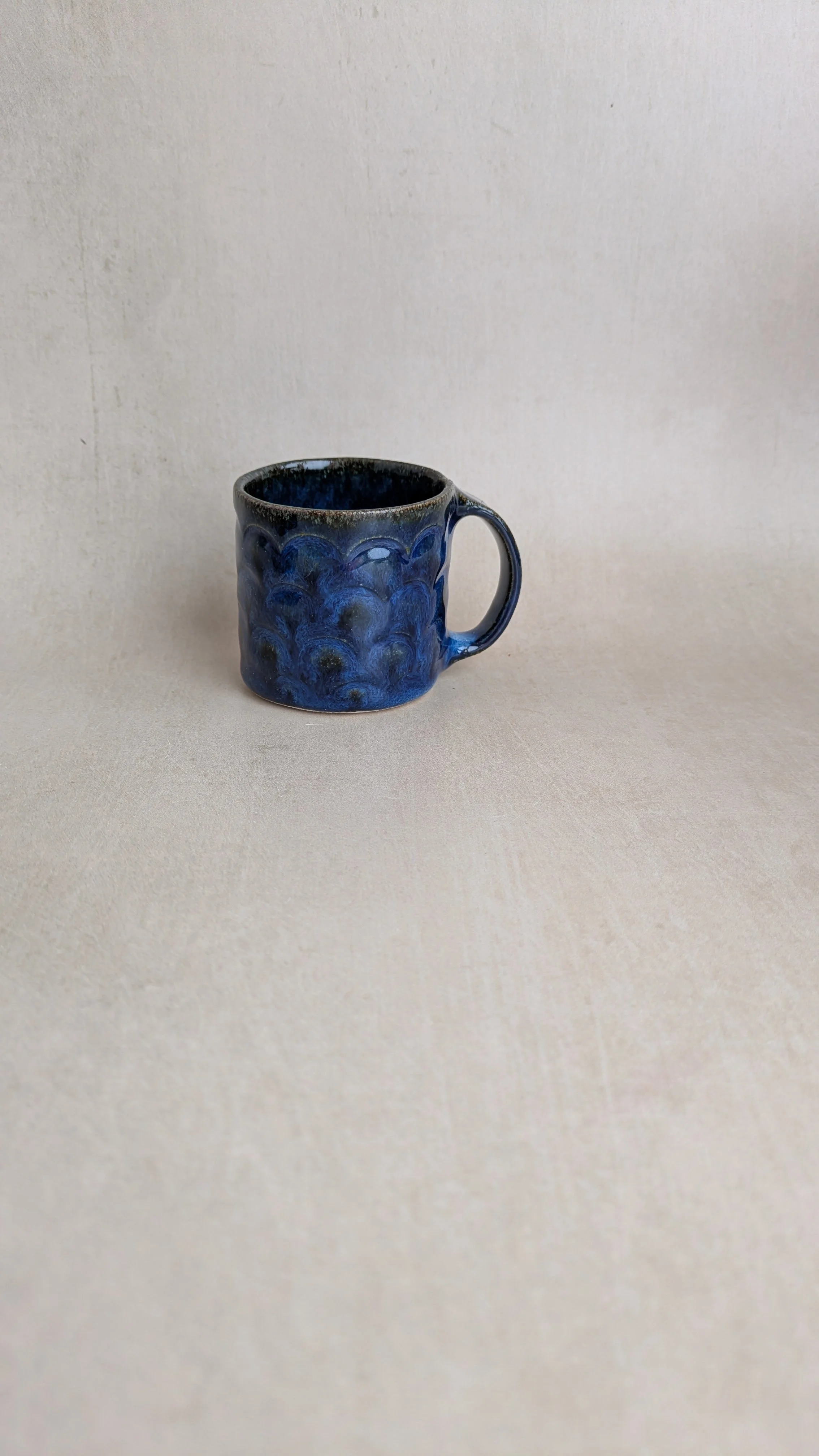 Single Azul Lazuli mug with arch texture and glossy blue glaze on a neutral background.