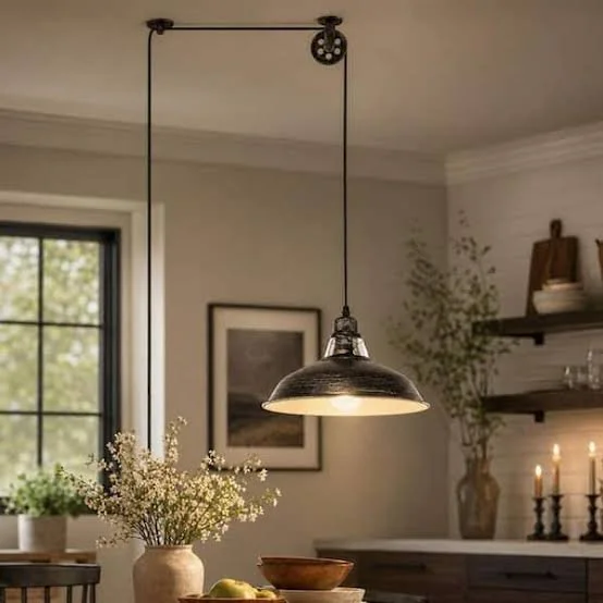Pendant light hanging over a table with a vase of flowers in a cozy home kitchen.