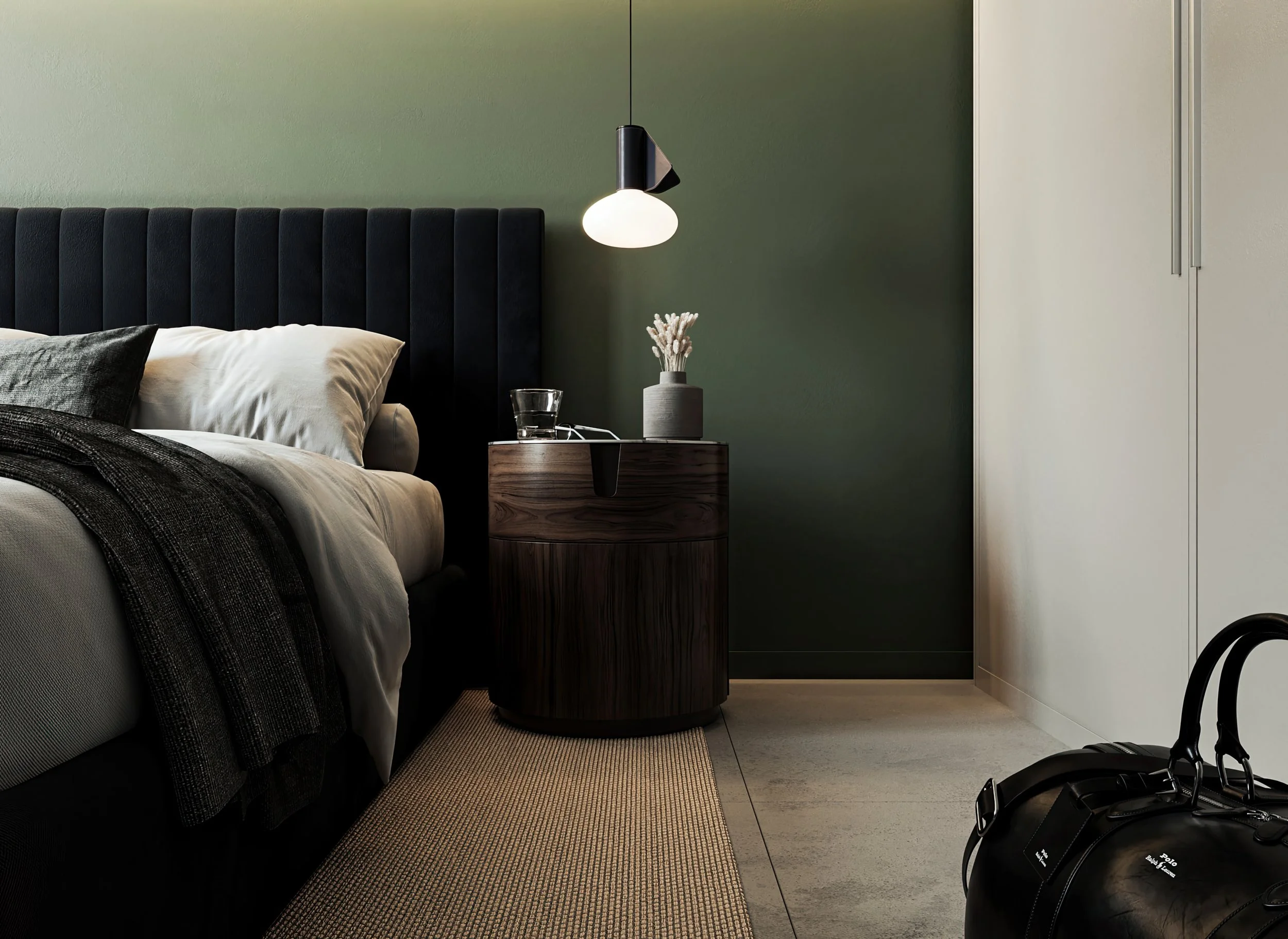 Modern bedroom interior vignette 3D render with a black channel-tufted headboard, dark green accent wall, round wooden nightstand, hanging pendant lamp, and a black leather duffel bag on a concrete floor.
