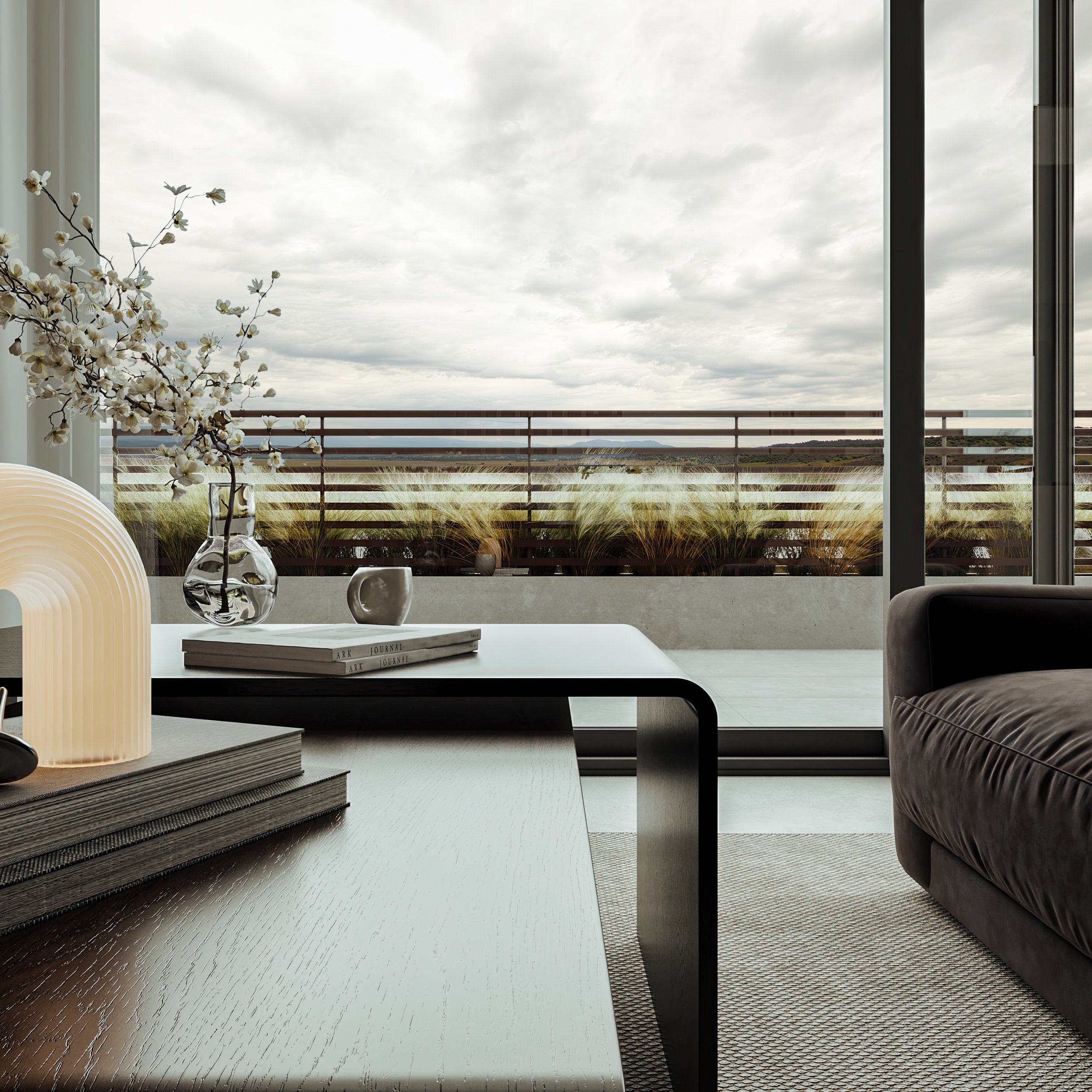 Modern luxury living room interior detail shot featuring an arched glowing table lamp, cherry blossom vase, and coffee table decor styling. Floor-to-ceiling balcony doors open to a private terrace with ornamental grasses and overcast sky