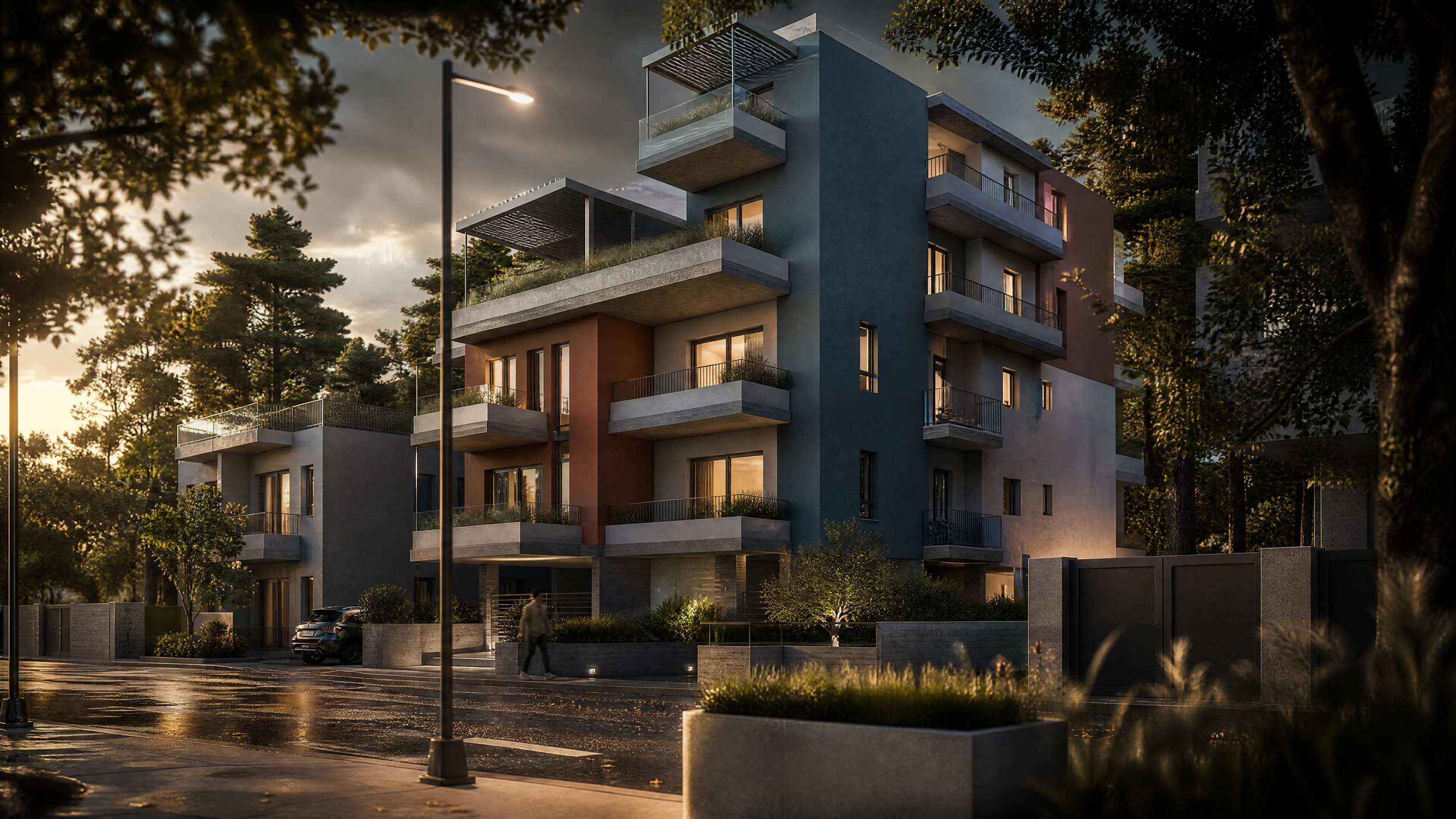 Modern multi-story residential building with colorful exterior walls, balconies, and large windows, surrounded by trees and streetlights at dusk.