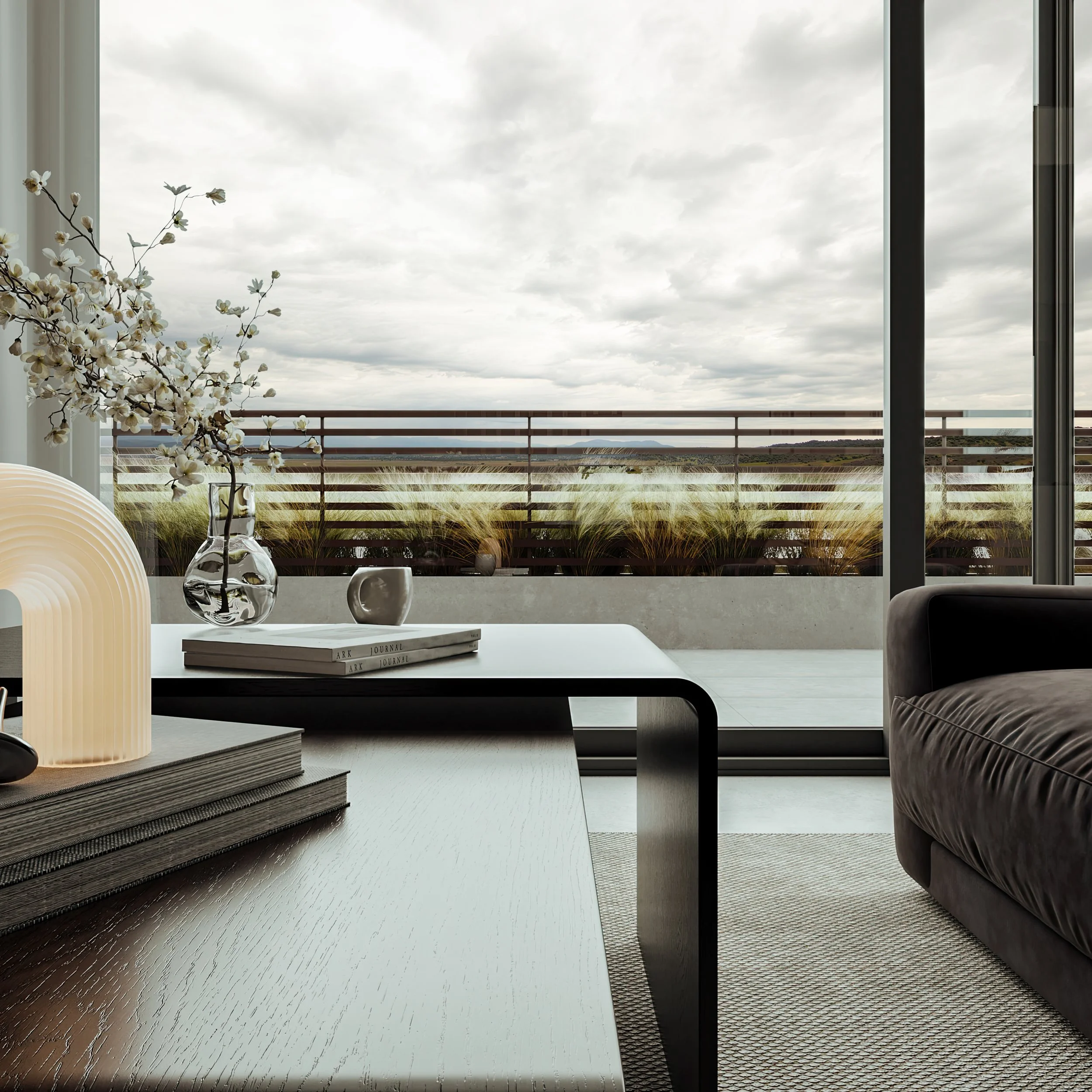 Modern living room with an open window showing a cloudy sky, a wooden balcony railing, and indoor decor including a vase with flowers, books, and a lit table lamp.
