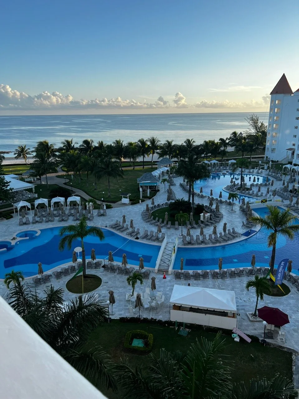 Scenic view of a luxury beachfront resort with pools overlooking the ocean.