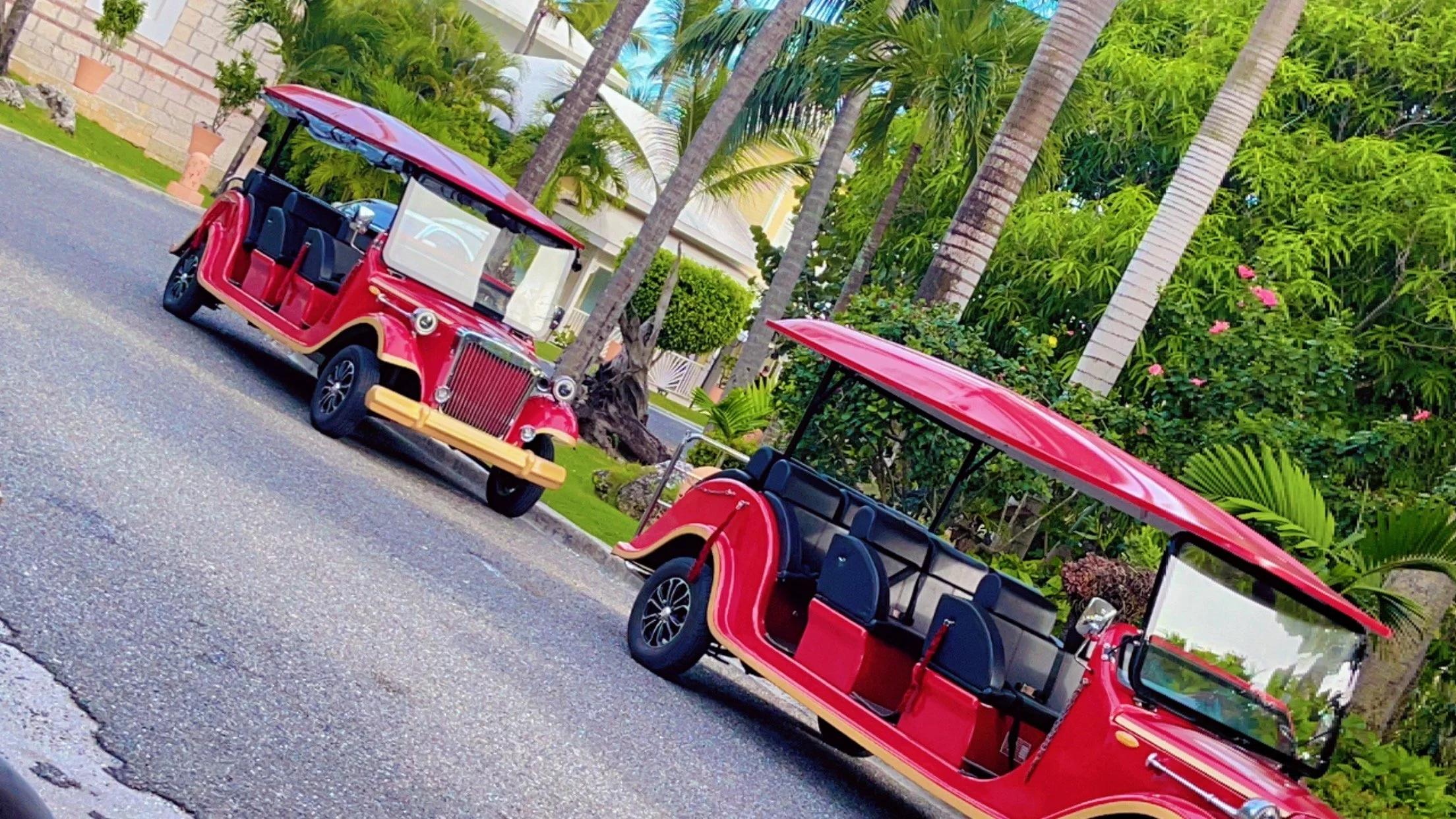 Resort shuttle carts transporting guests through a tropical vacation resort.