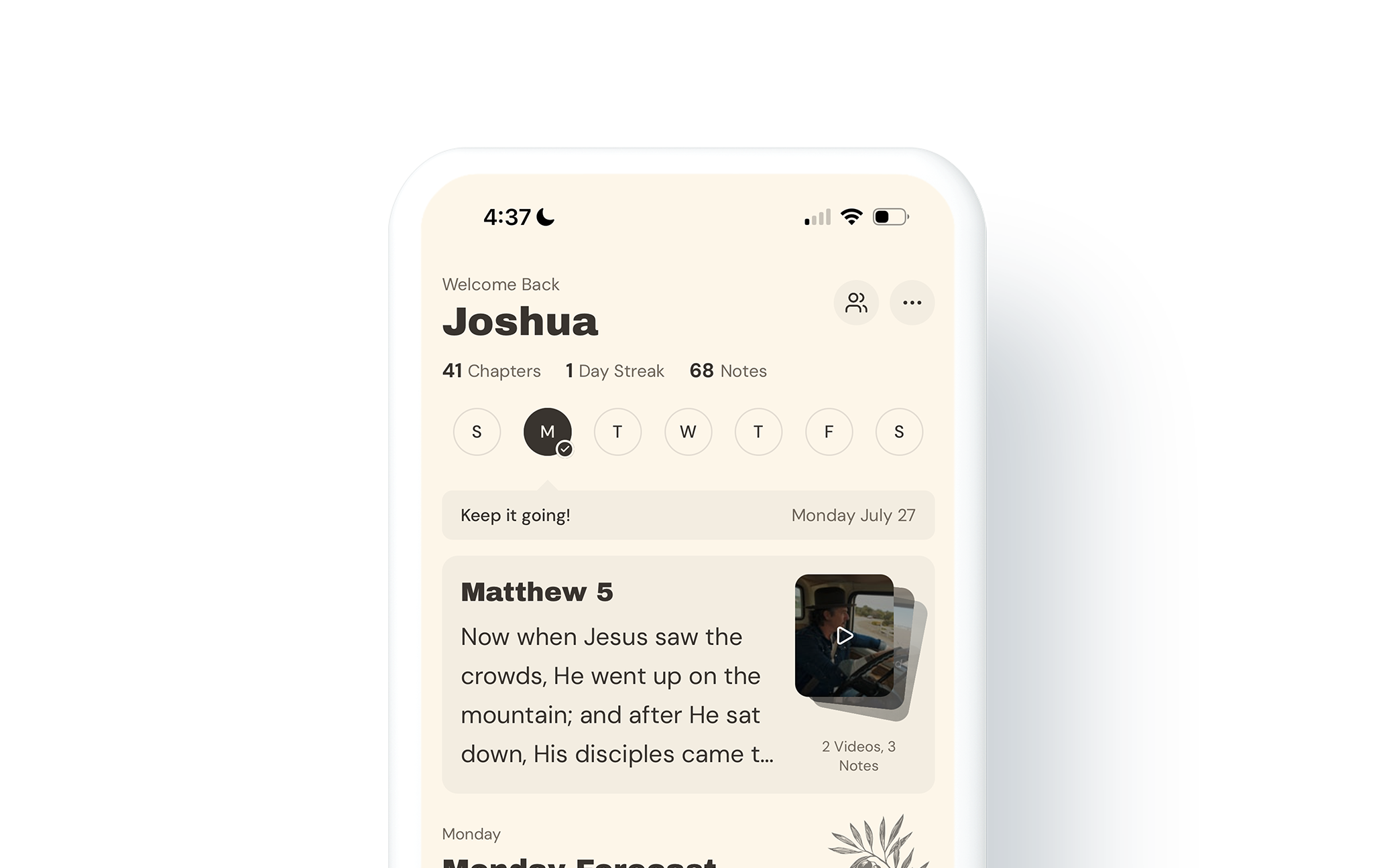 Close-up of a smartphone screen displaying a Bible reading app with a daily devotional entry for Matthew 5, featuring a paragraph of text, a video thumbnail, and navigation icons.