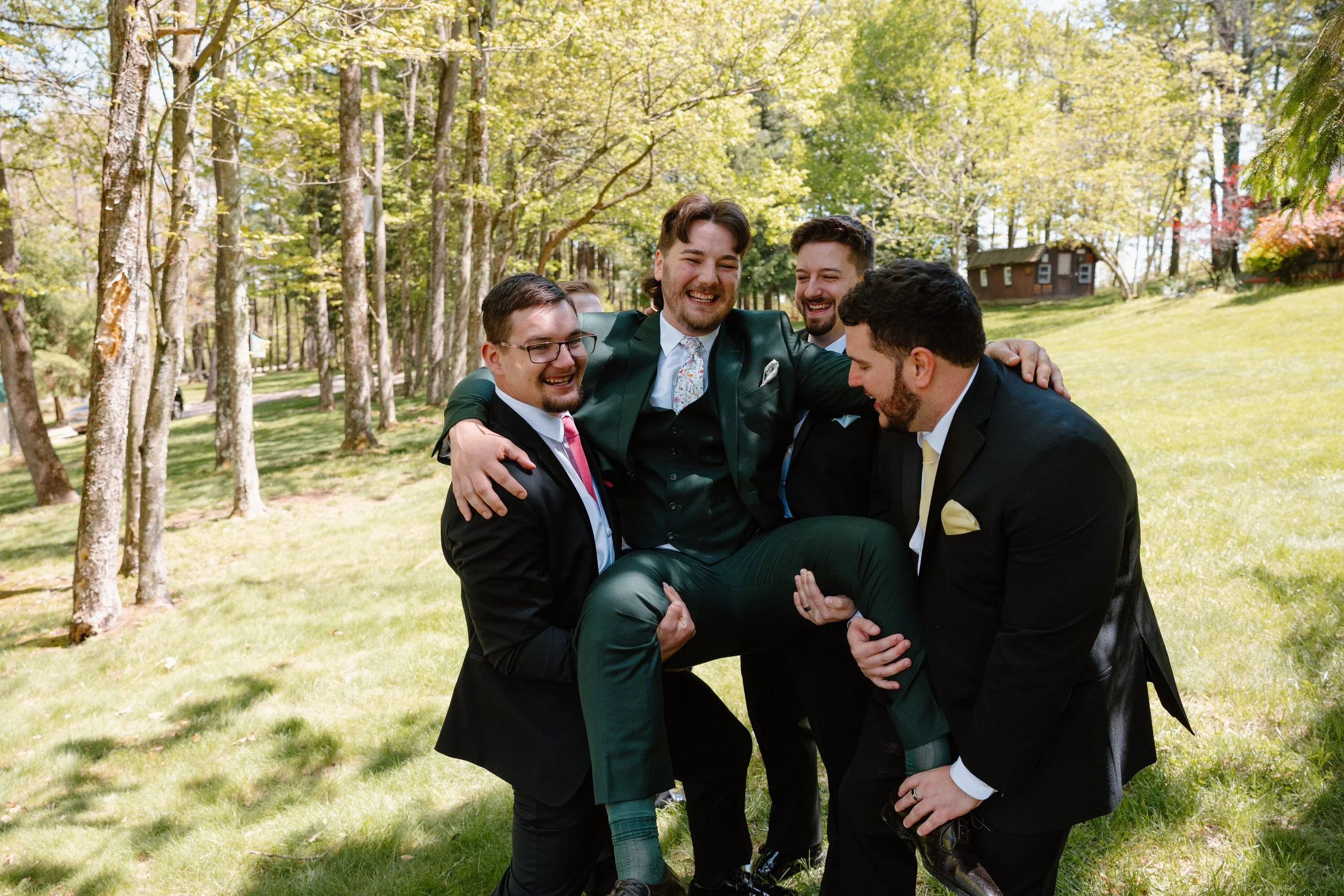 groomsmen-holding-groom-mohican-castle-wedding.jpg
