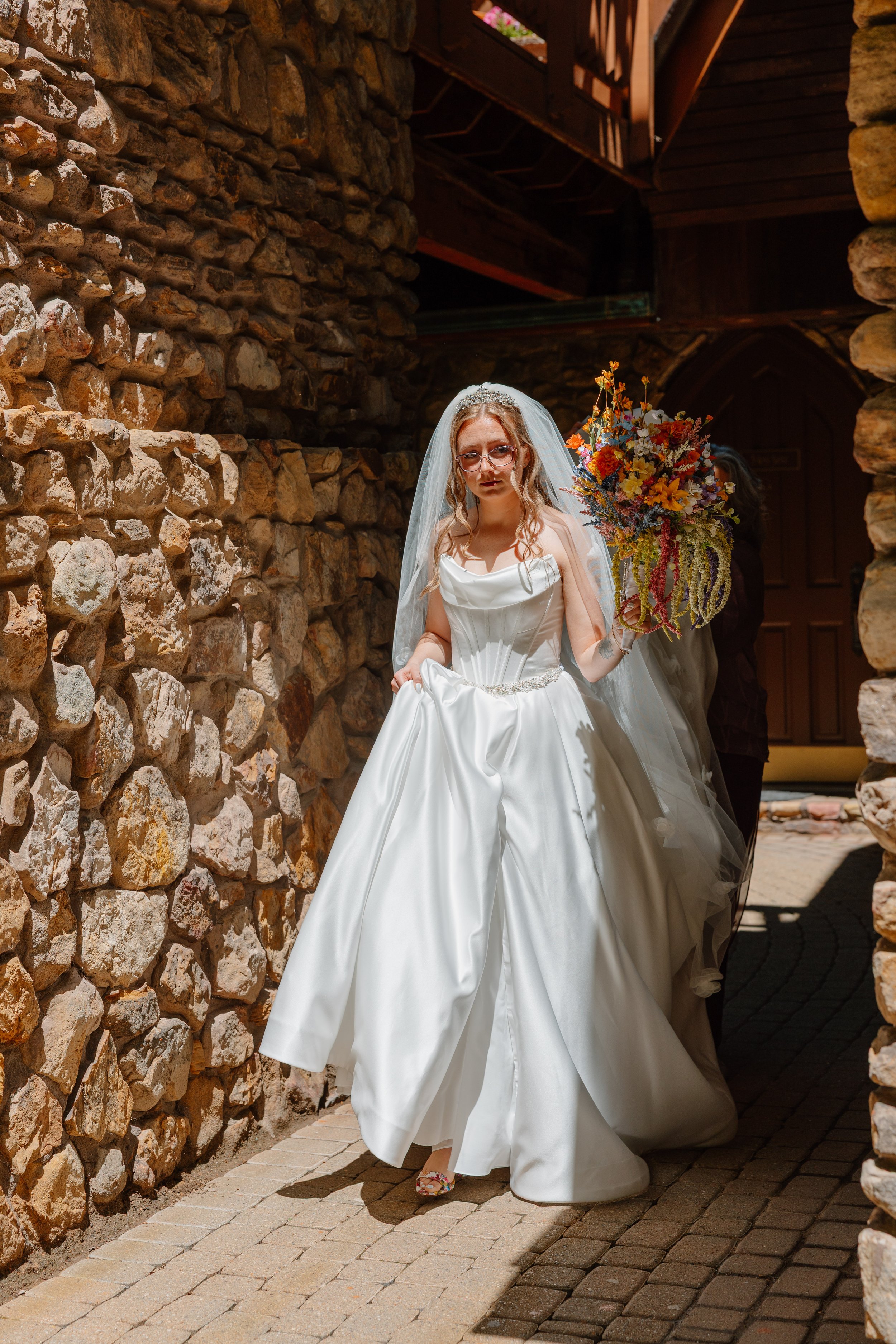 landolls-mohican-castle-bride-walking-stone-arch.jpg