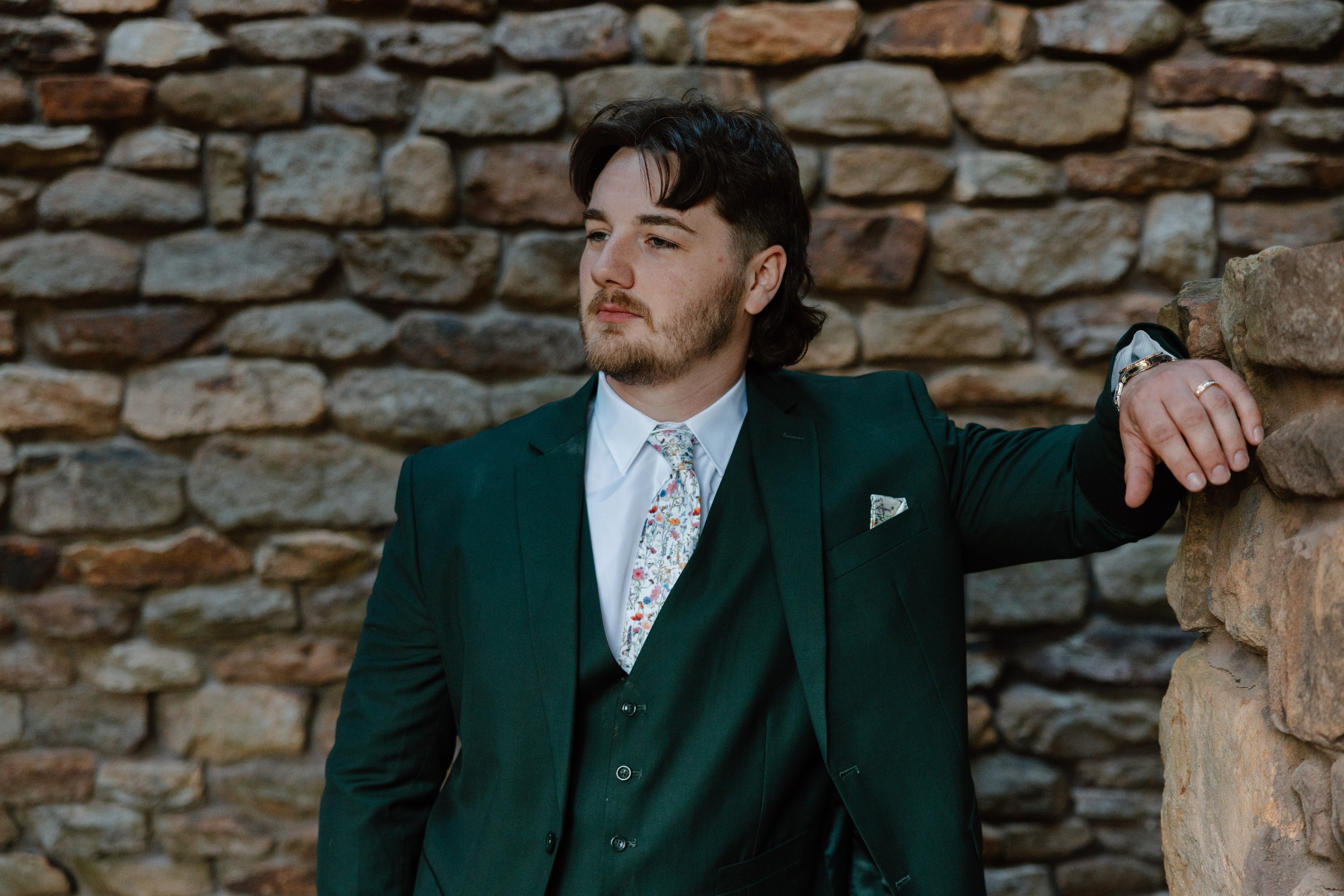 landolls-mohican-castle-groom-stone-wall-portrait.jpg