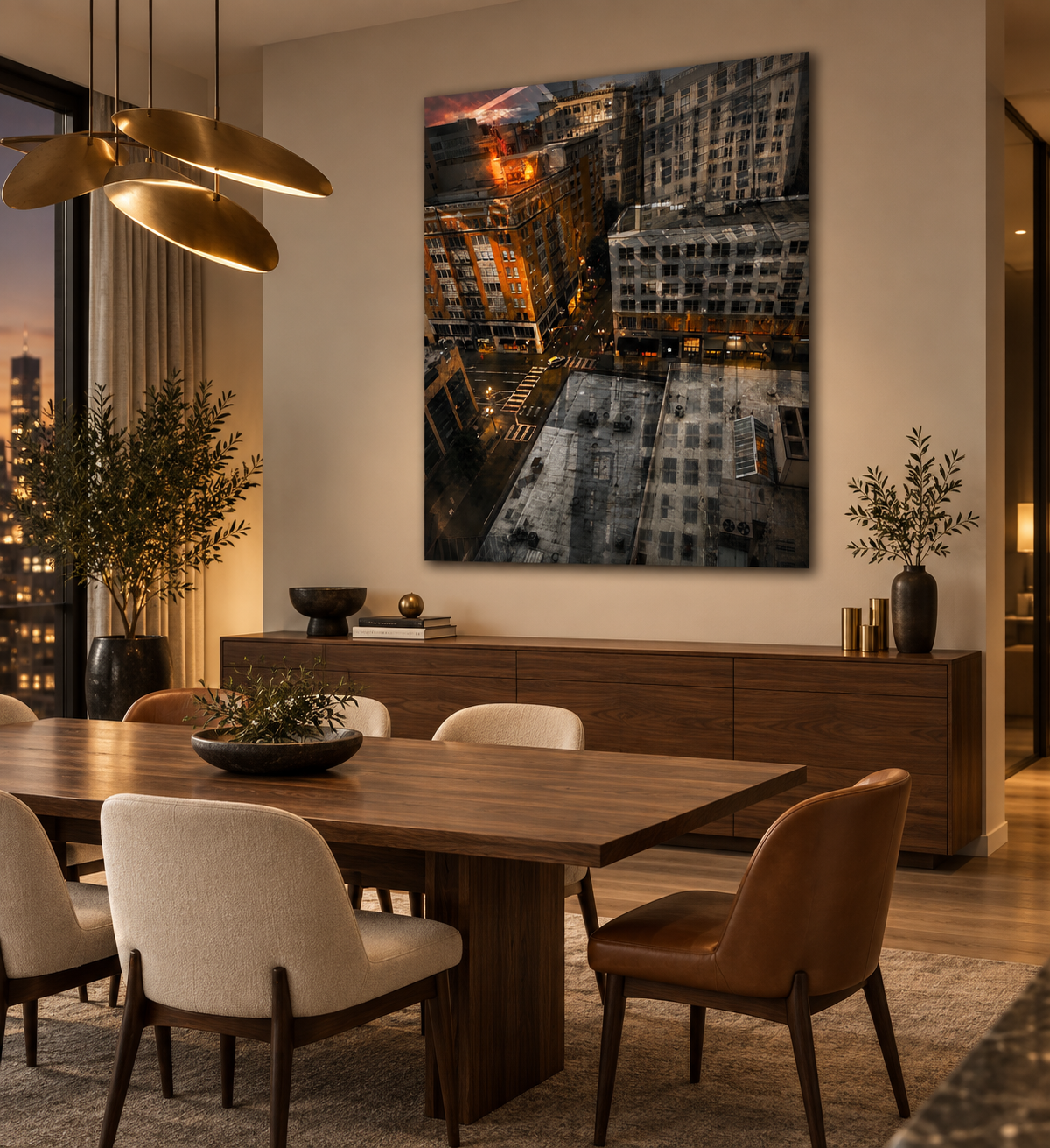 Interior of a modern dining room with a wooden table, surrounding beige and brown chairs, indoor plants, decorative objects on a sideboard, a large cityscape photograph on the wall, and warm lighting.