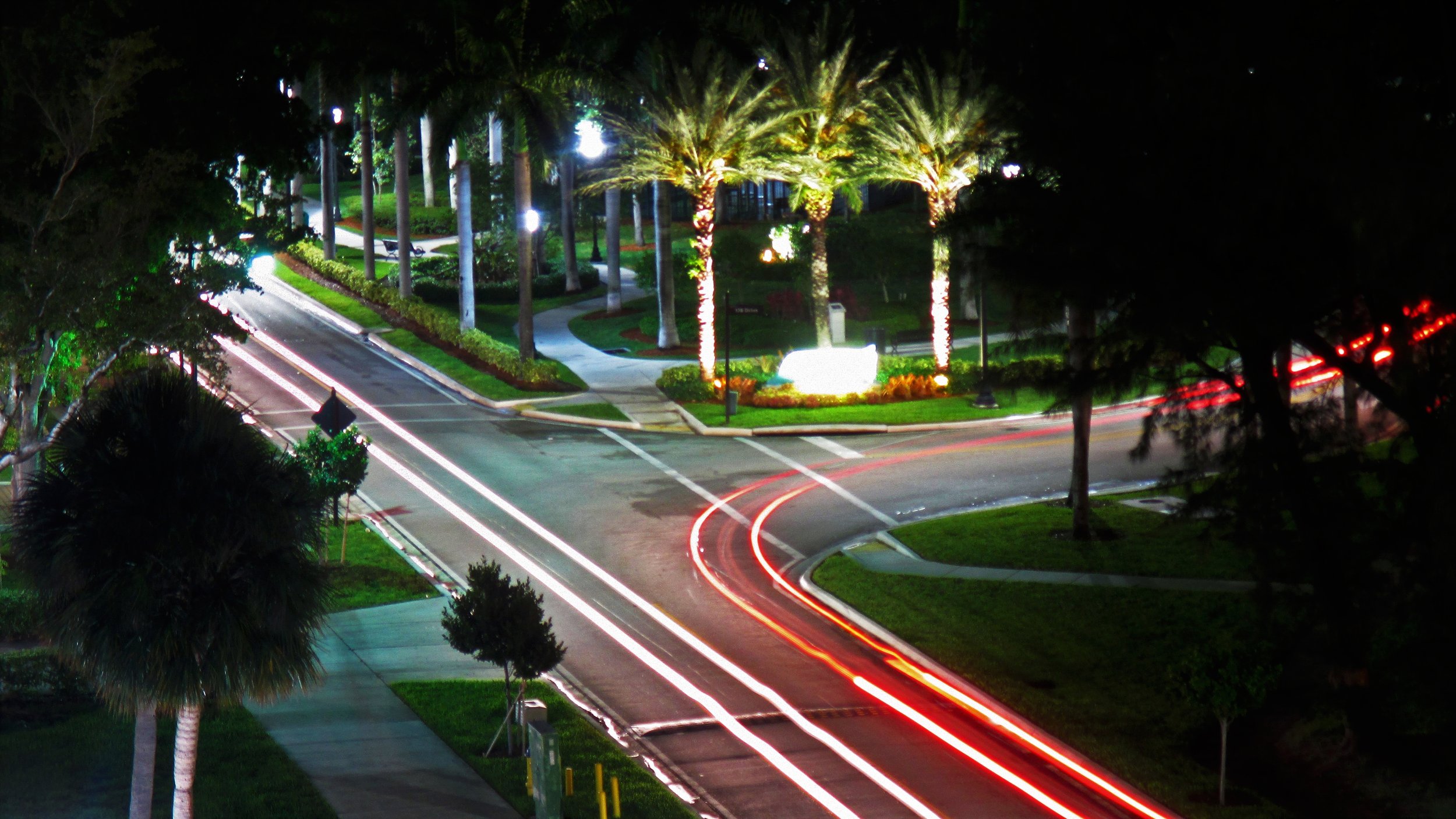Long exposure photo of cars passing by North Bay Road and 178th Drive by Senator Gwen Margolis Park.