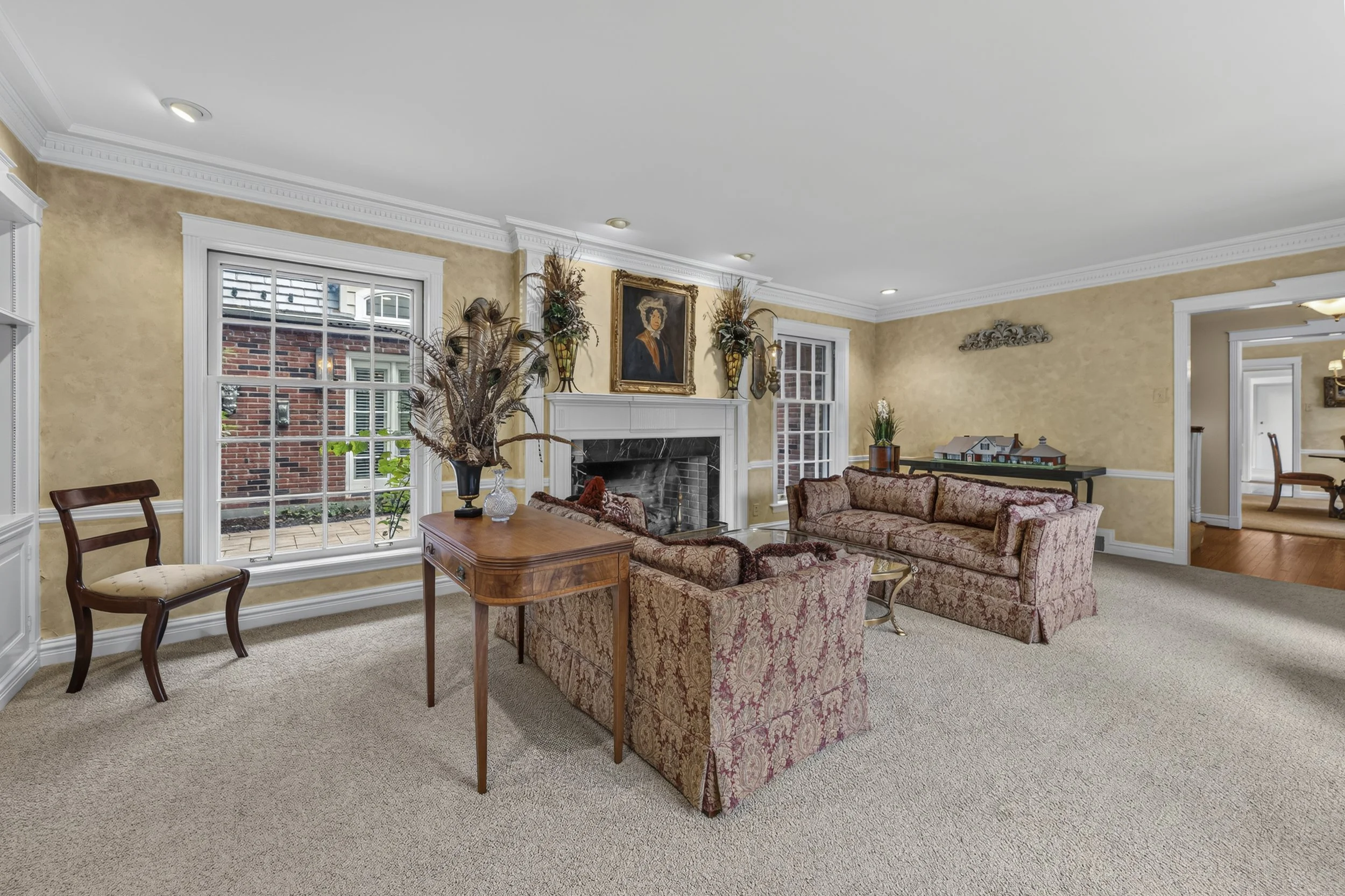 Spacious living room featuring a fireplace, elegant finishes, and comfortable gathering space.