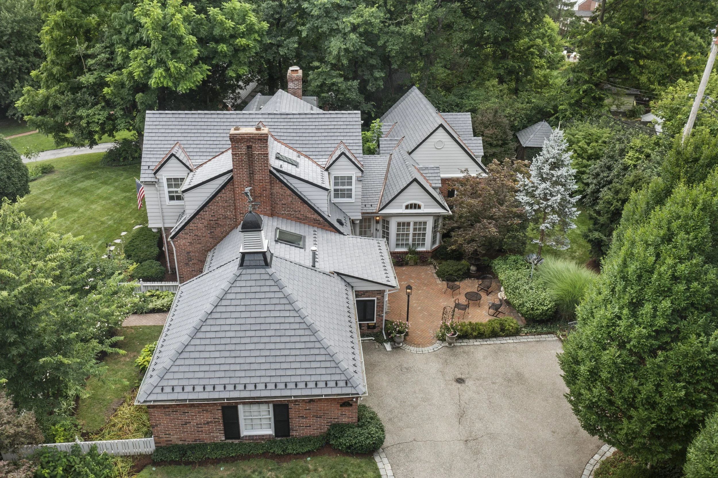 Aerial view of 17 Devon Road highlighting the home's architecture, mature landscaping, and private outdoor living areas.