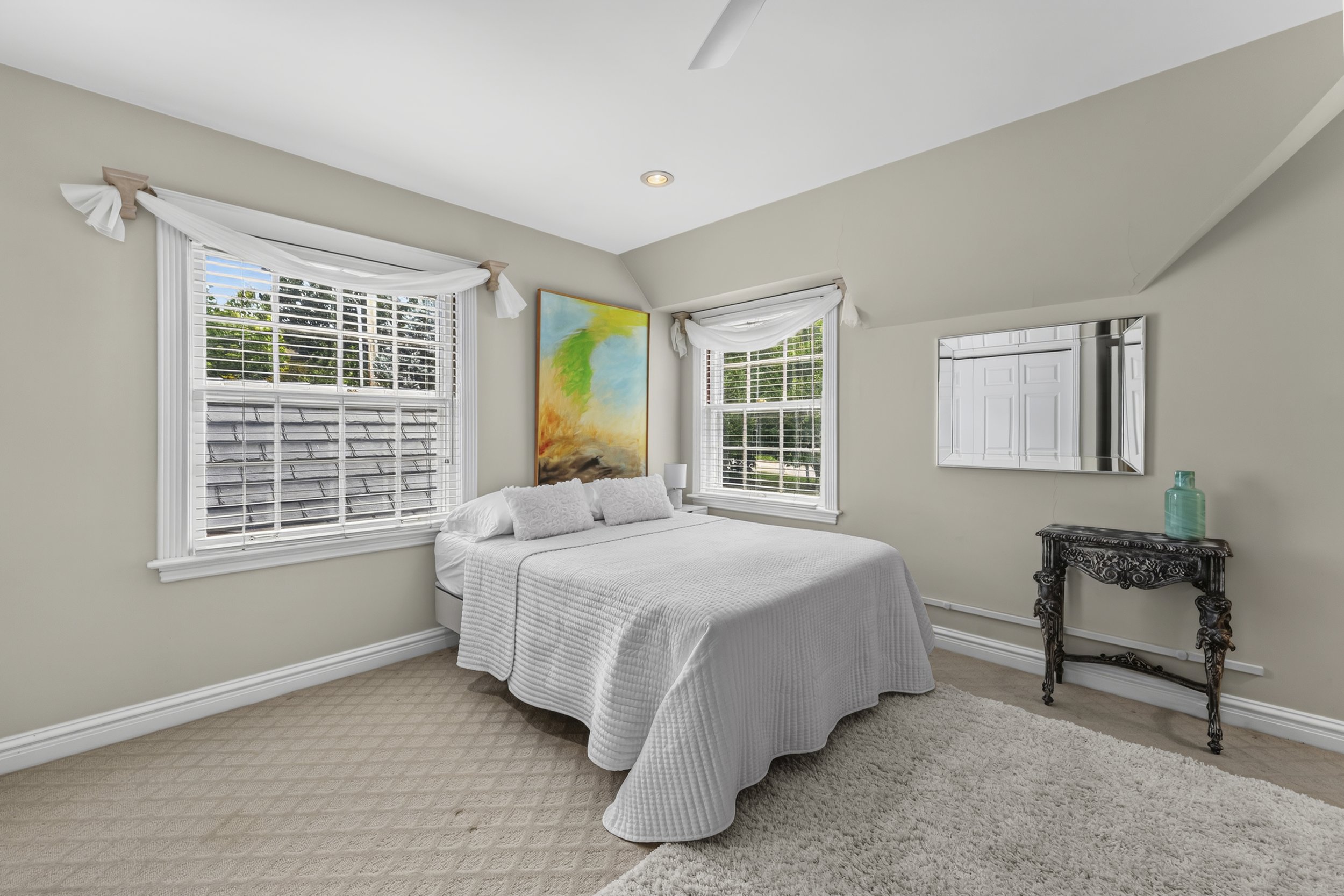 Bedroom featuring classic architectural details and views of the surrounding landscape.