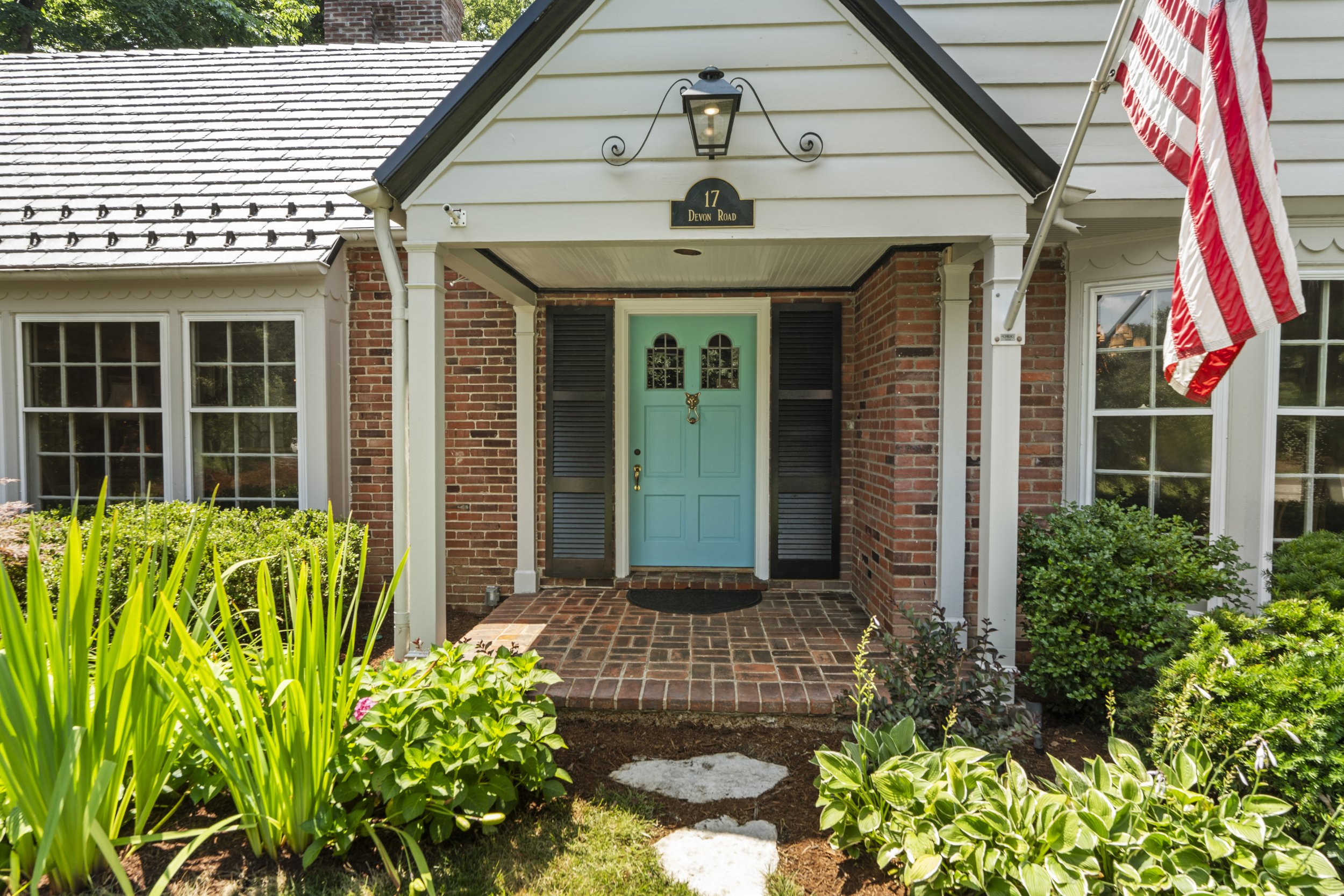 Front entry of 17 Devon Road with covered porch, landscaped walkway, and welcoming curb appeal.