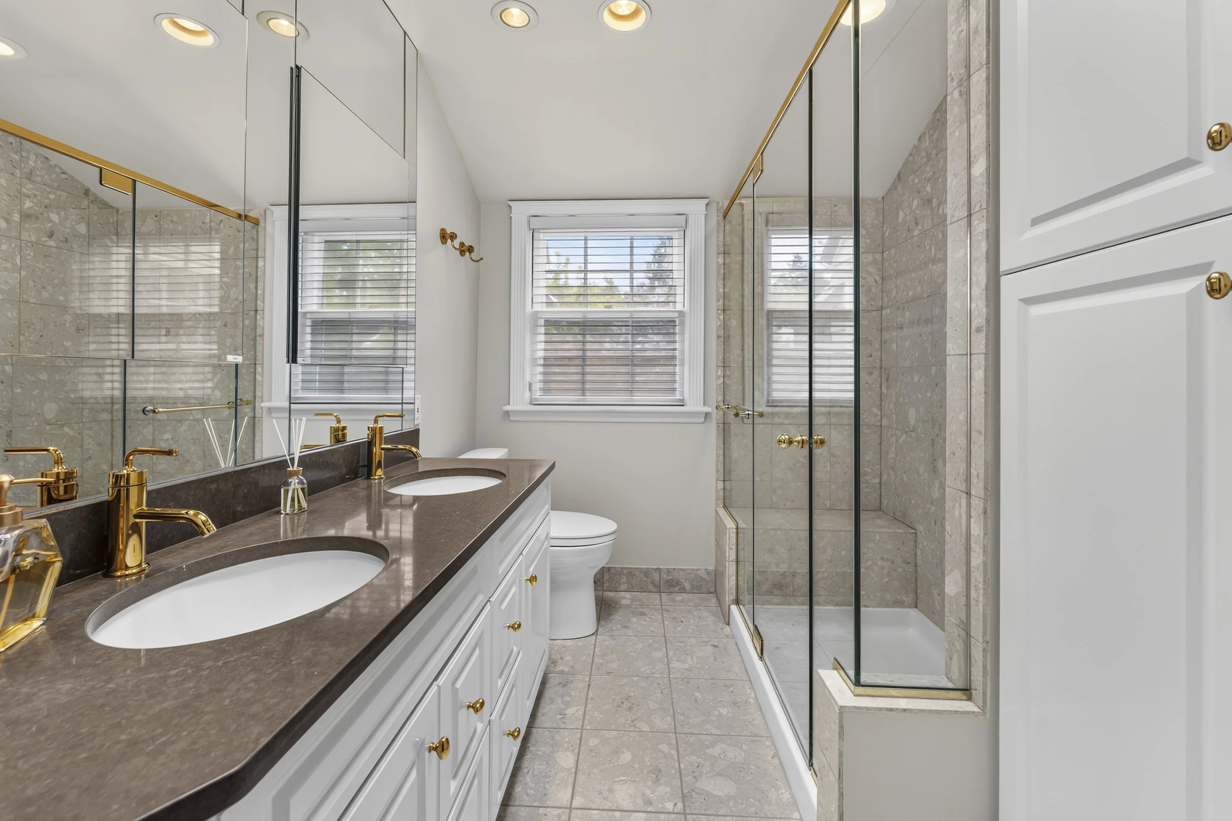 Updated bathroom with quality fixtures, abundant natural light, and timeless finishes.