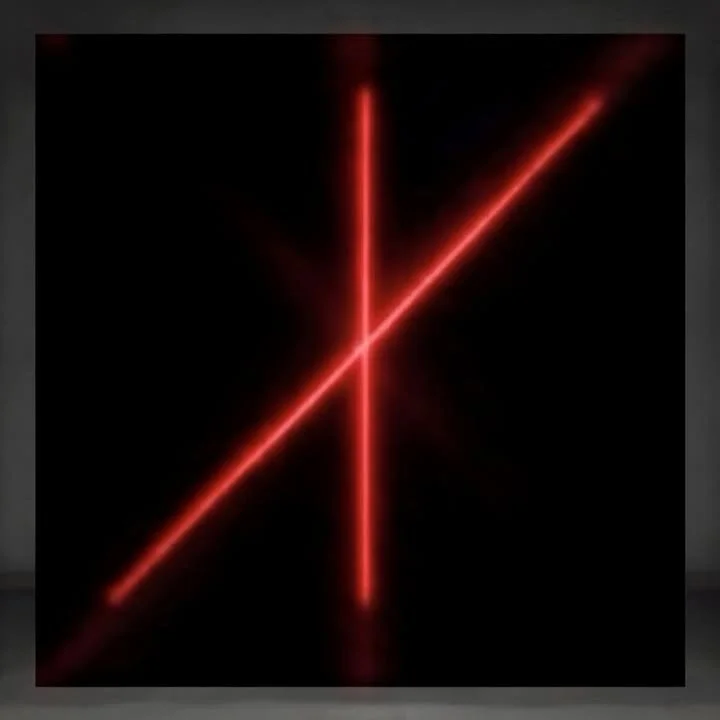 Red neon light in a crisscross pattern on a black background.