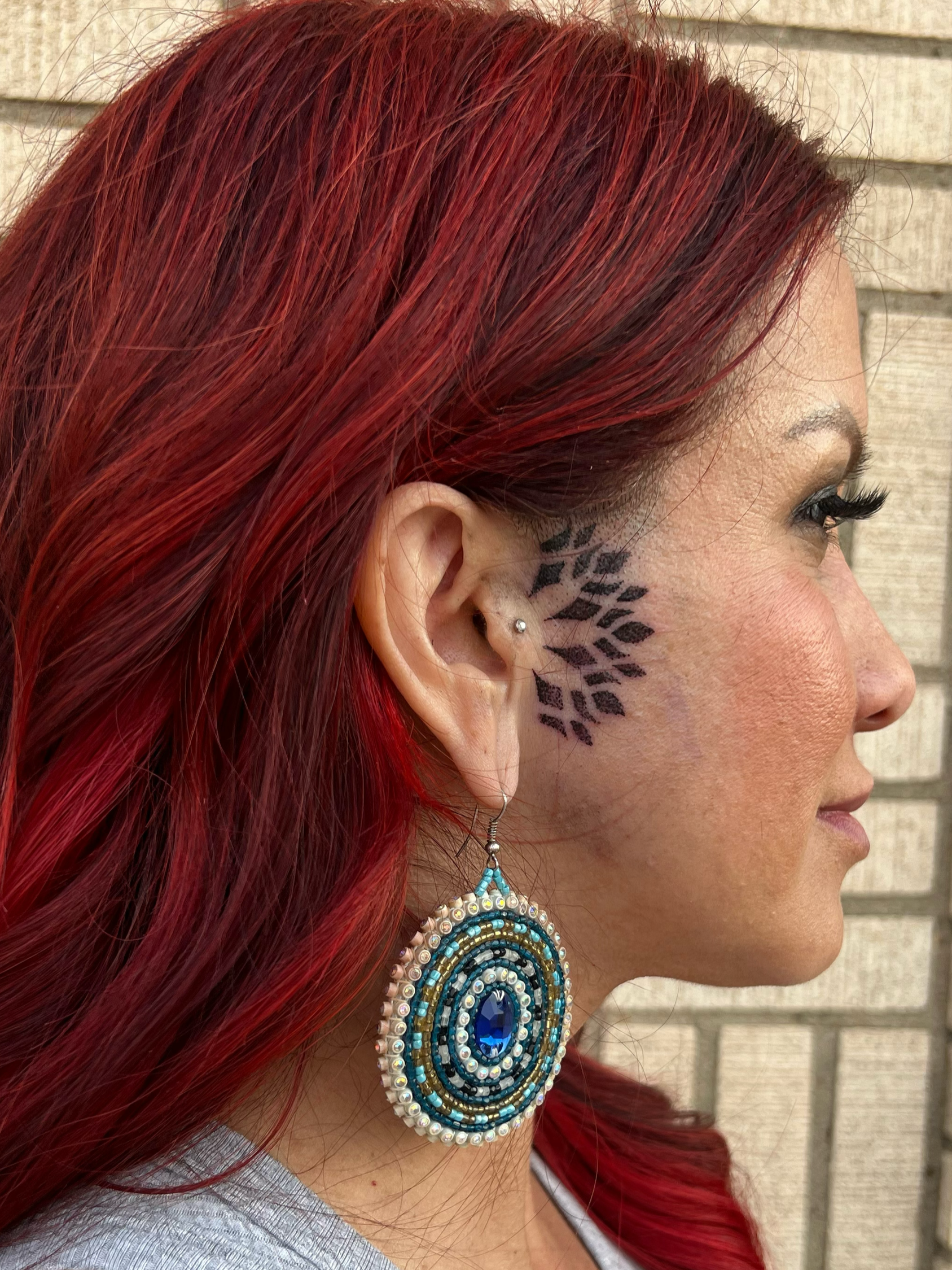 mandala dot work geometric tattoo by the ear 