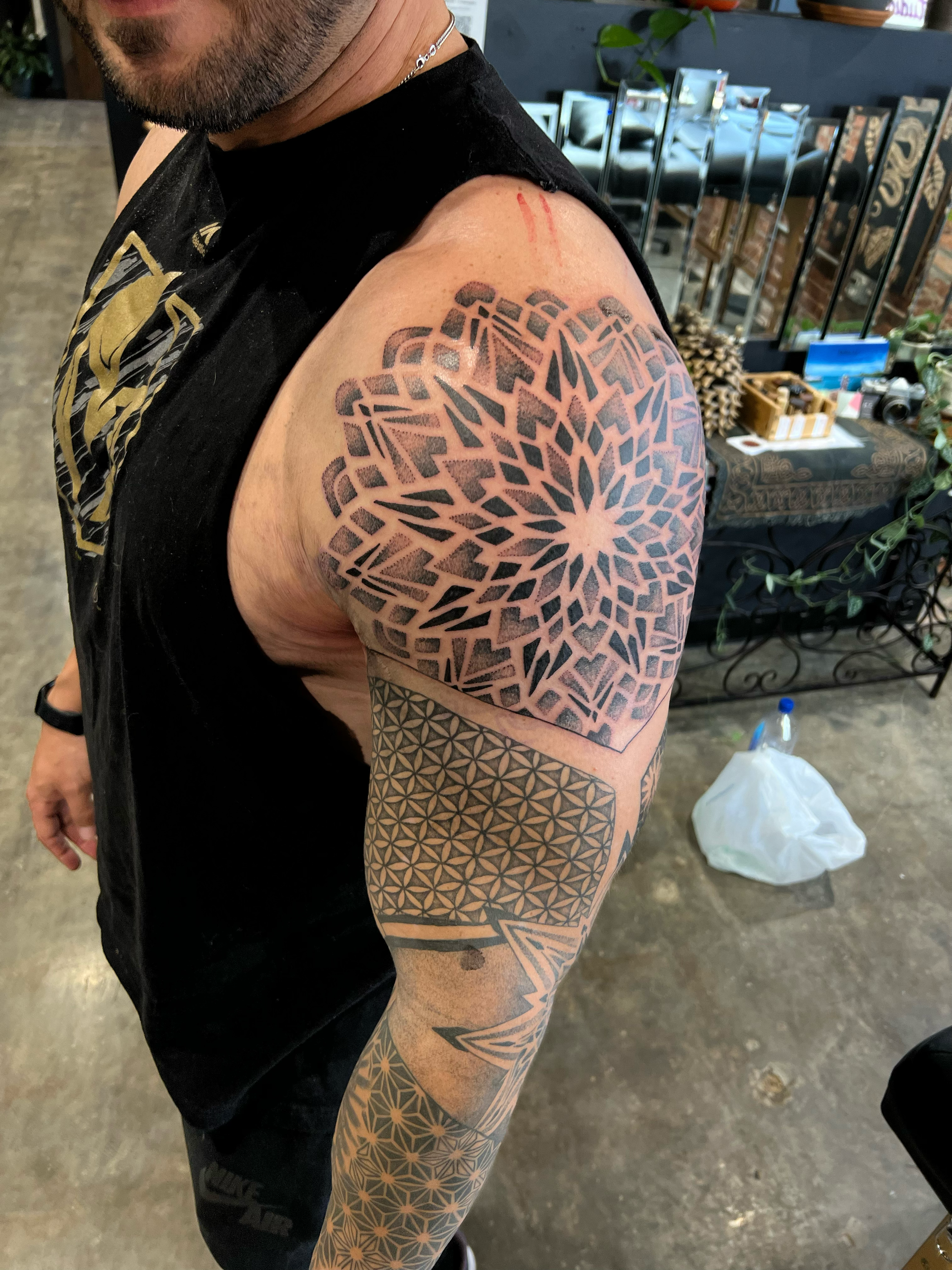 geometric arm sleeve focused on a dot work mandala on the shoulder 