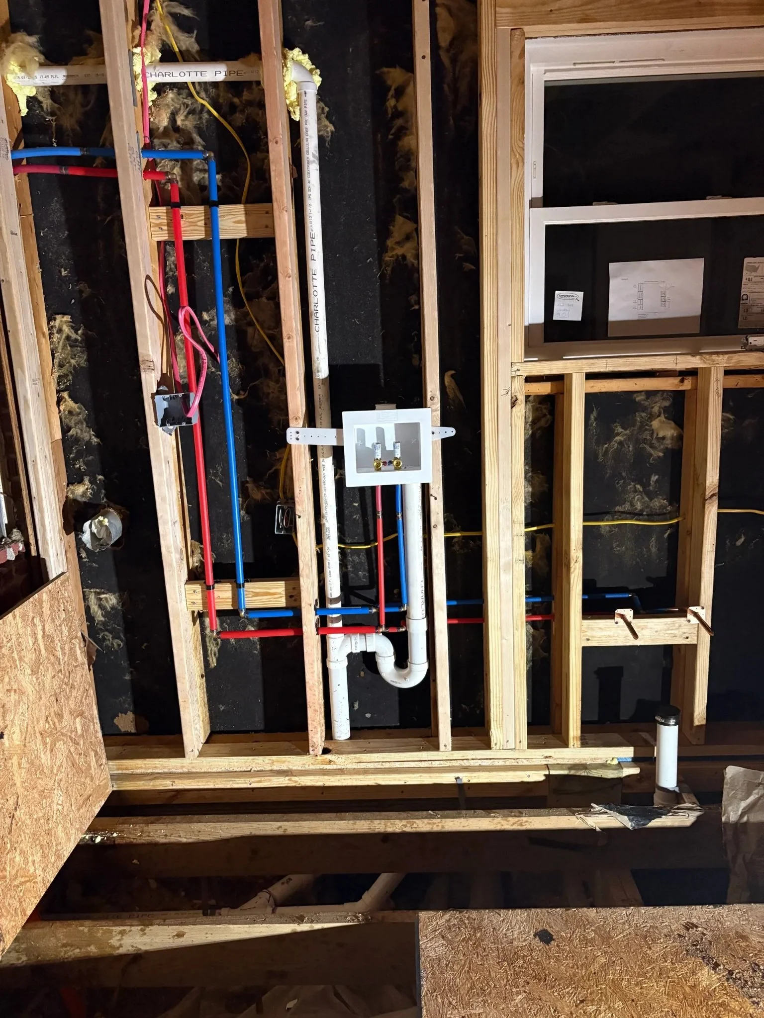 New water lines and drain pipes installed during a plumbing rough-in in Pensacola, Florida