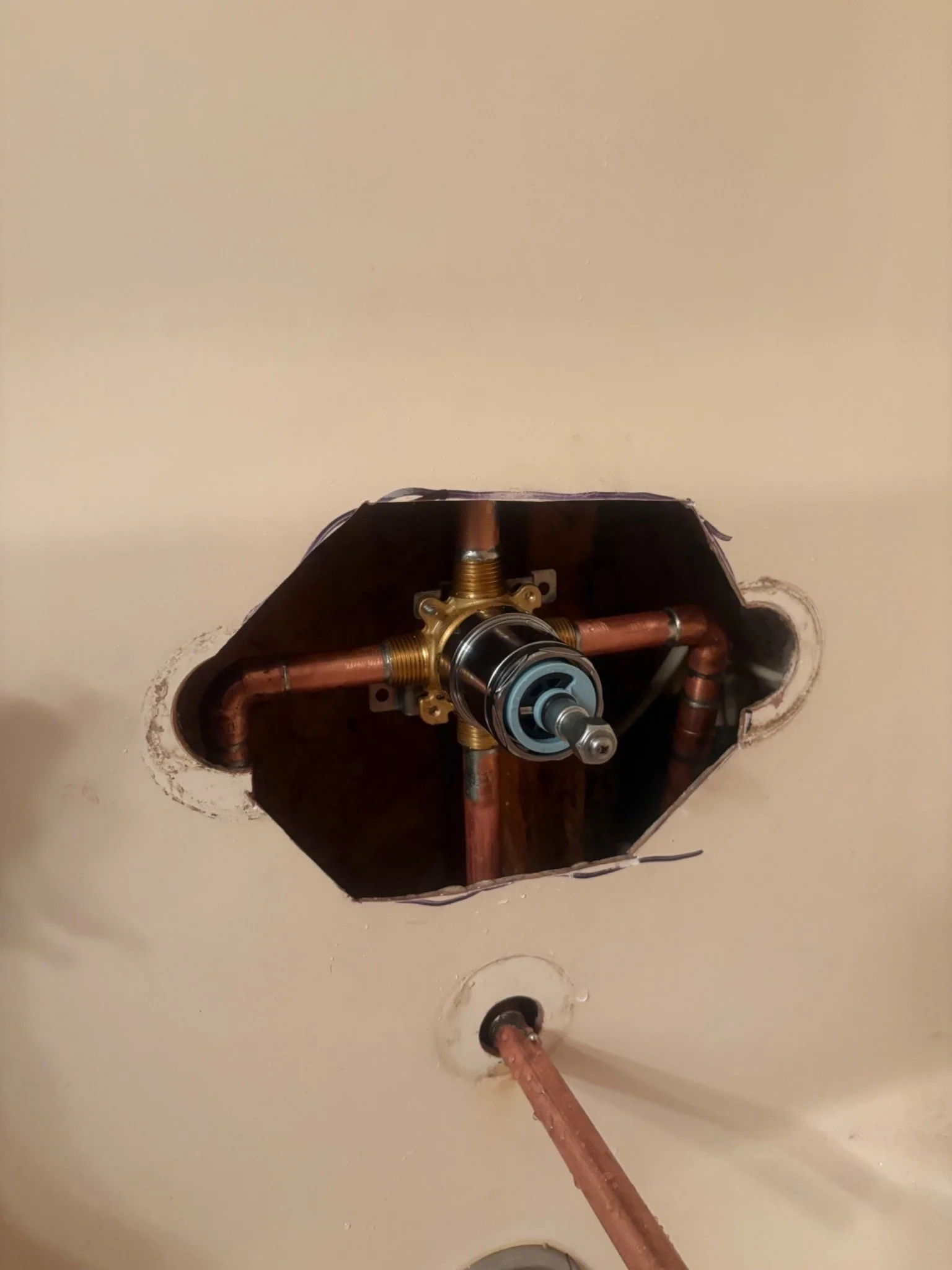 New shower valve and copper plumbing installed inside a bathroom wall in Pensacola, Florida