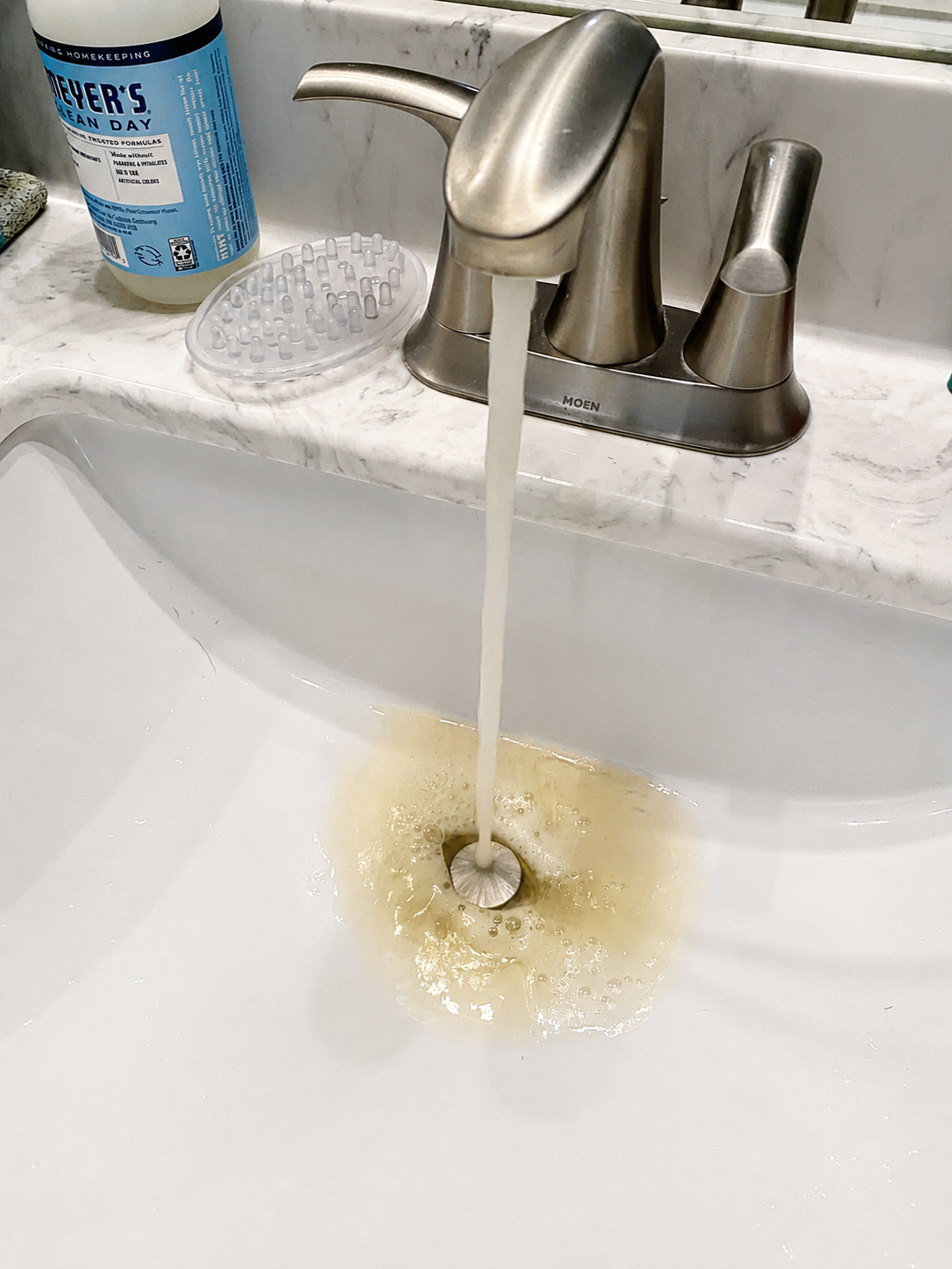 Discolored water flowing from a bathroom faucet before a whole-home repiping project in Pensacola, Florida