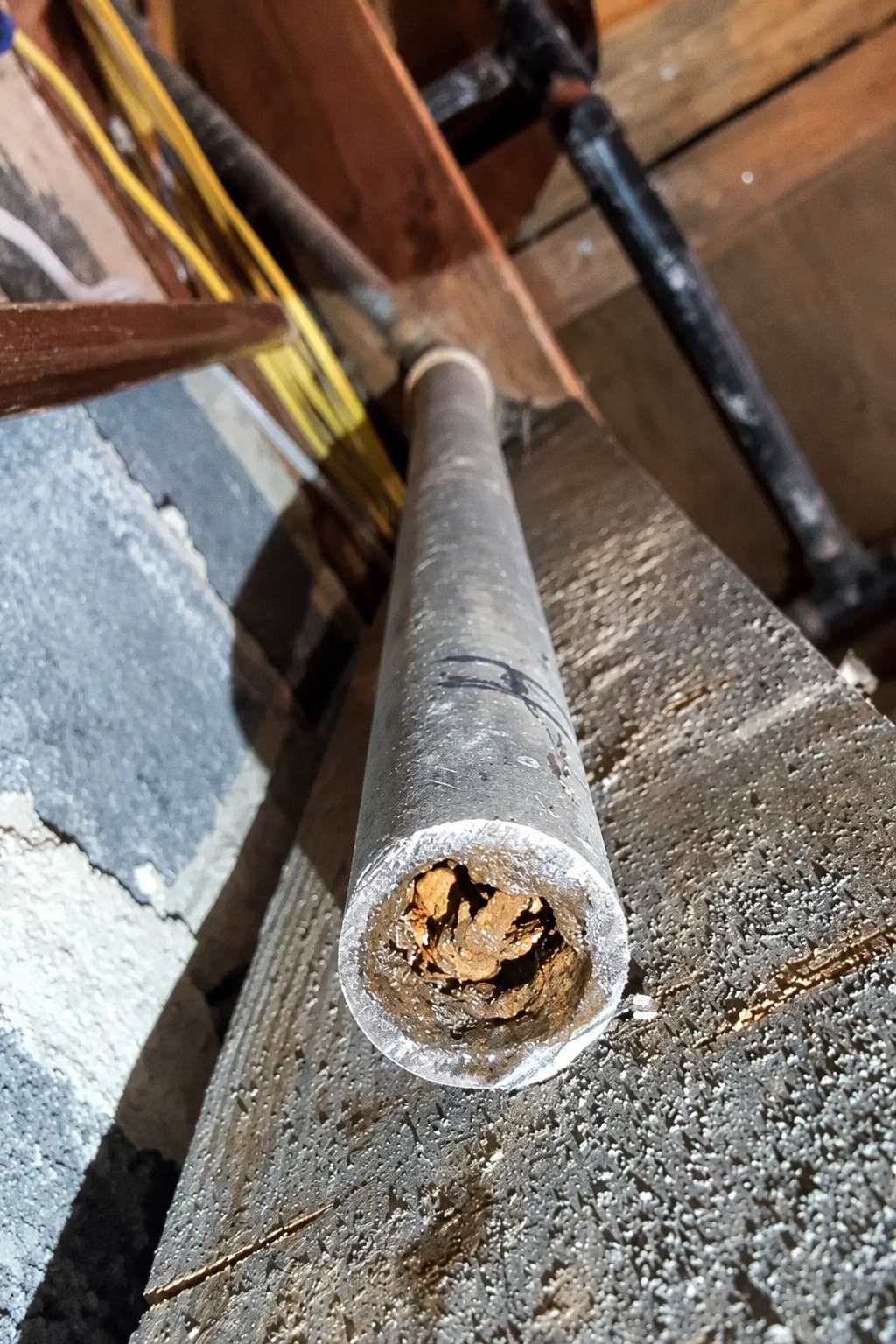 Old galvanized water pipe clogged with rust and mineral buildup before replacement in Pensacola, Florida