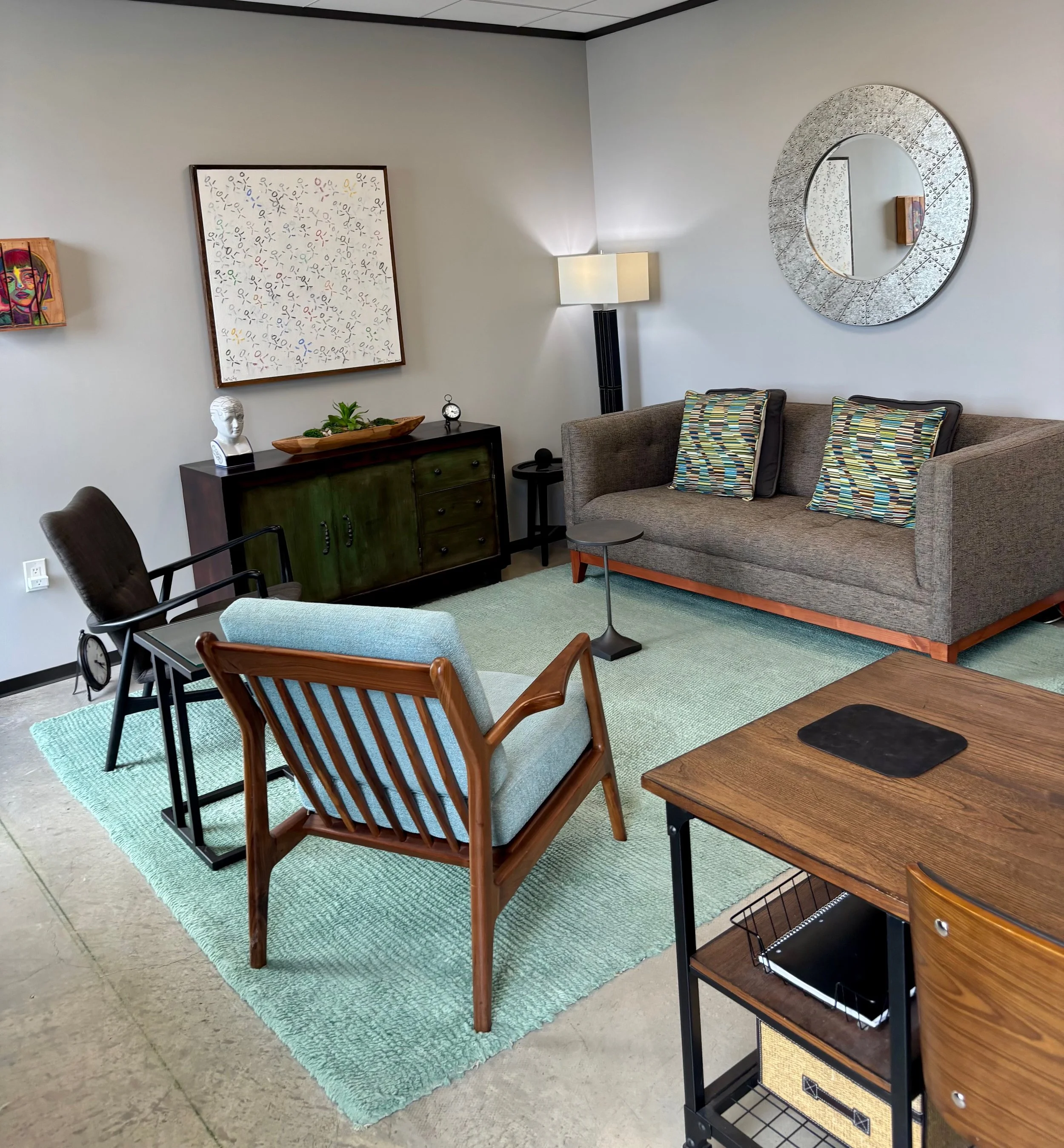 Luis Peña's warm, sunlit therapy office in Houston, with a sofa and armchair