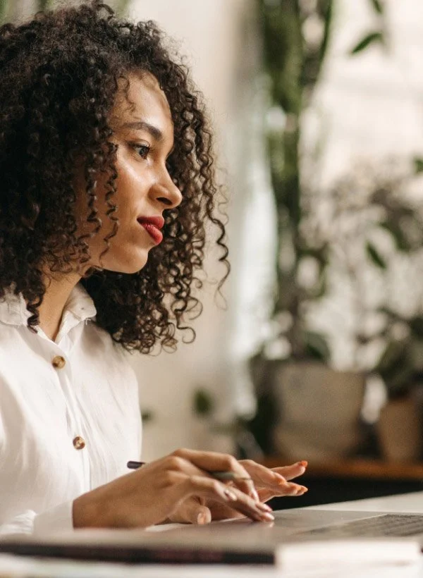 A woman typing on her laptop