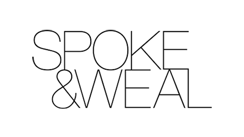 Black logo of Spoke & Weal salon set in a thin font all caps.