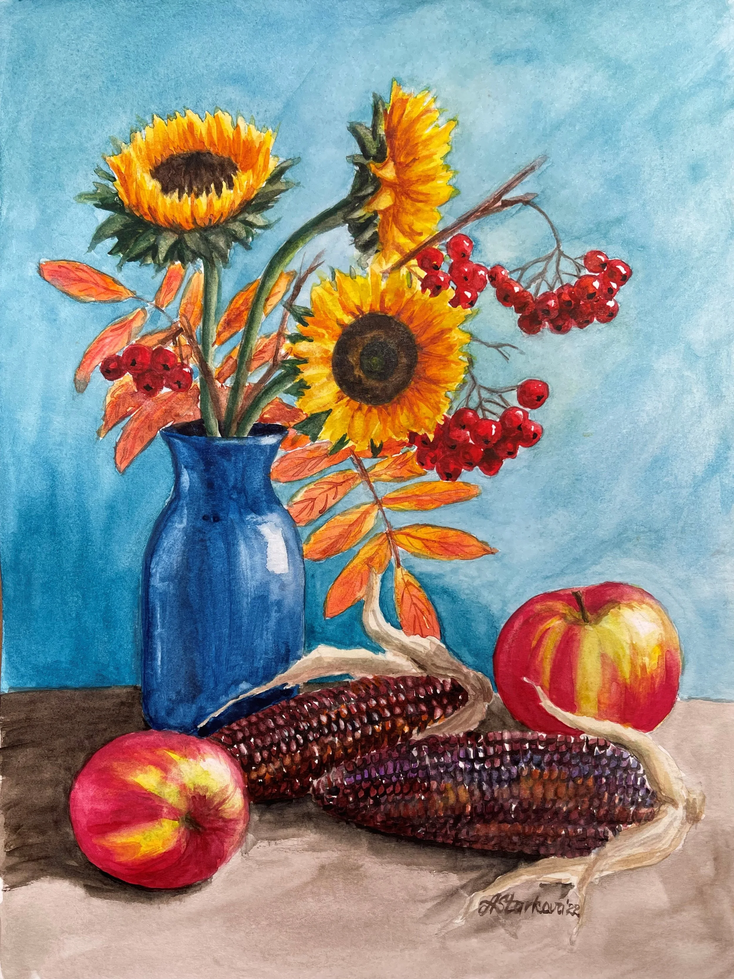 Watercolor painting of a still life with a blue vase holding sunflowers and orange autumn leaves, red berries, apples, and indian corn with a blue background.