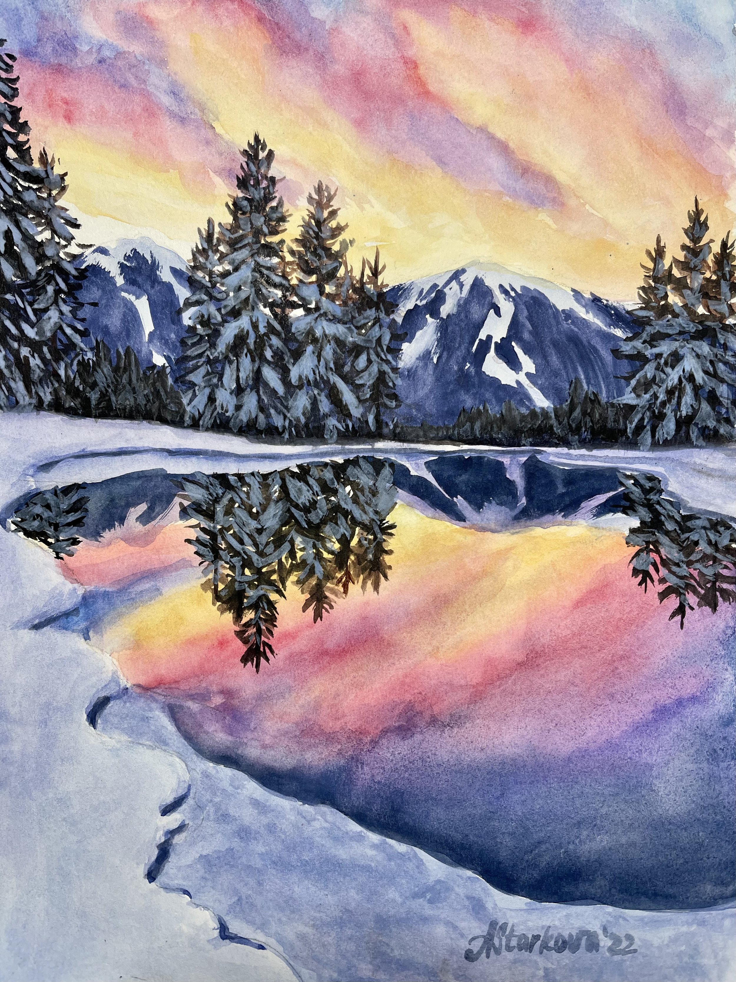 A watercolor painting of snow-covered pine trees and mountain peaks at sunset, with colorful sky hues of pink, purple, yellow, and orange reflected in a calm lake.