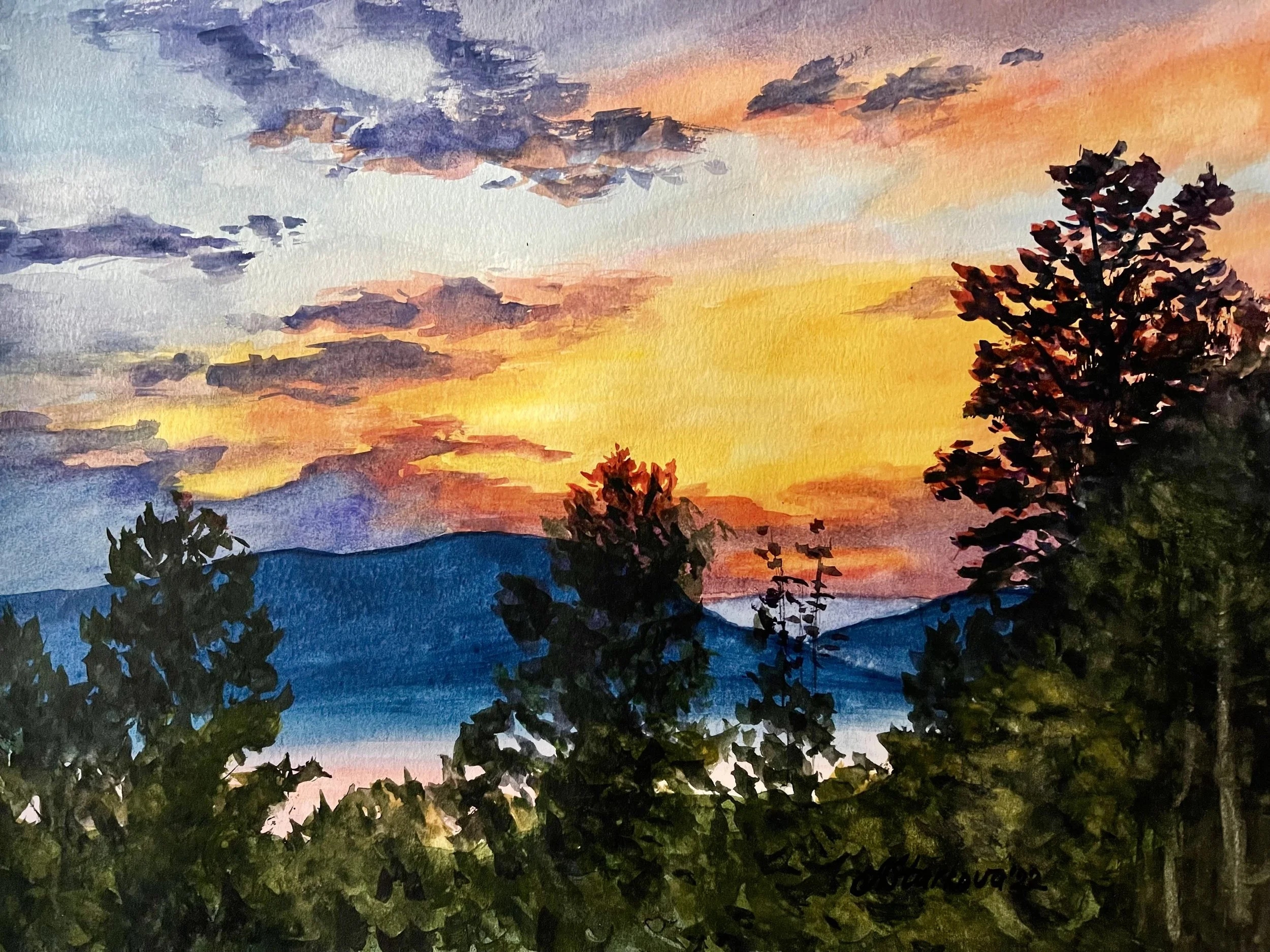 A watercolor painting of a sunset sky with colorful clouds, distant mountains, and silhouetted trees in the foreground.